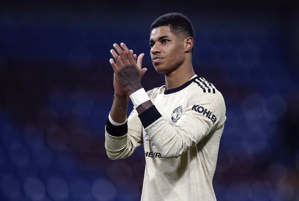 Footballer Marcus Rashford applauds following a game.