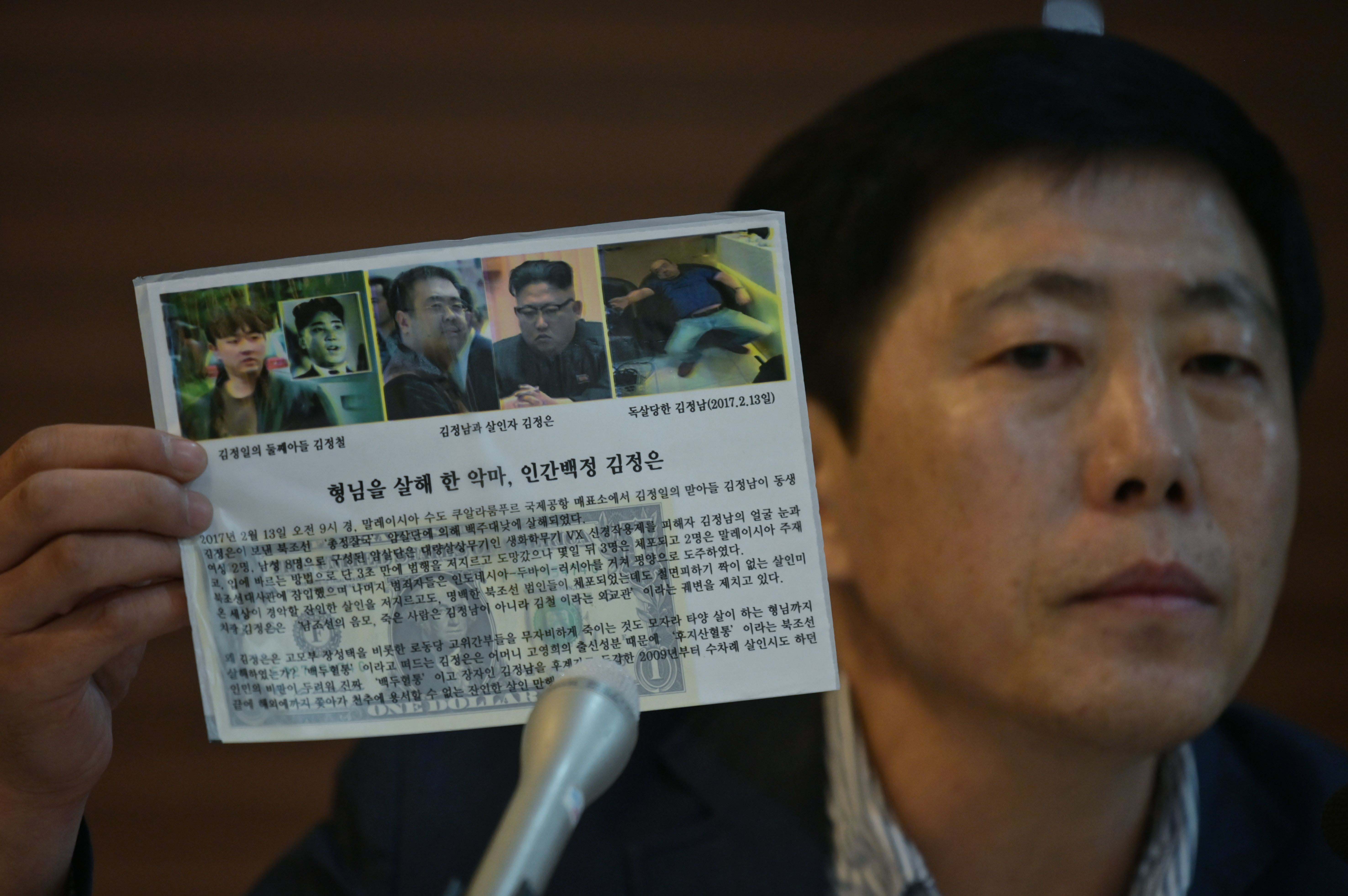 Activist Park Sang-hak holds a leaflet depicting the death of Kim Jong Nam, half-brother to North Korean leader Kim Jong Un, during a press conference in Seoul on July 6, 2020. © 2020 Photo by ED JONES/AFP via Getty Images