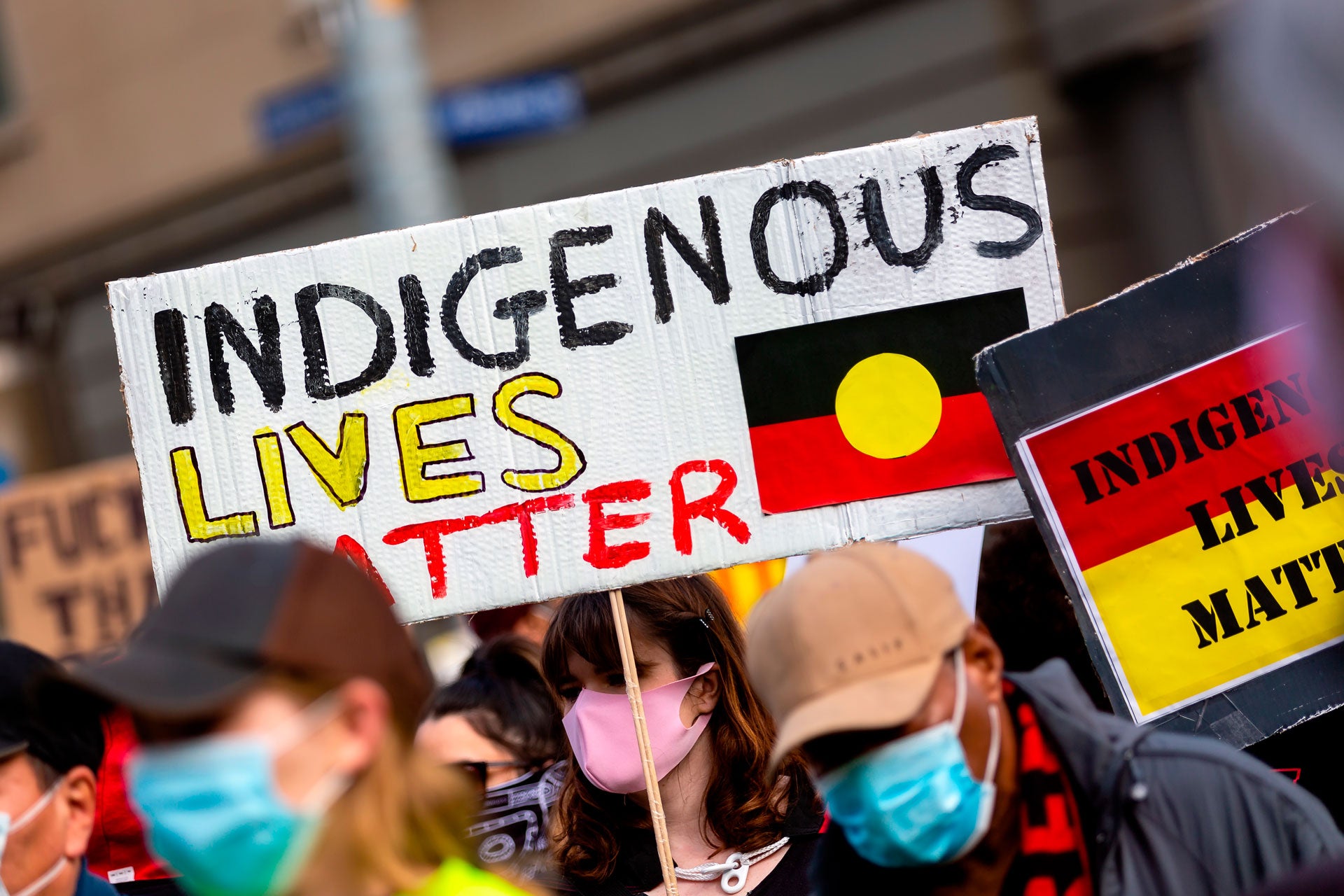 A woman holds an Indigenous Lives Matter placard during a Black Lives Matter rally on June 6, 2020 in Melbourne, Australia.