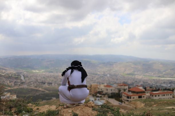 A Yemeni asylum seeker who arrived in Jordan in 2014, overlooks the city in the neighborhood of Abu Nseir, North of Amman, Jordan on March 25, 2021.