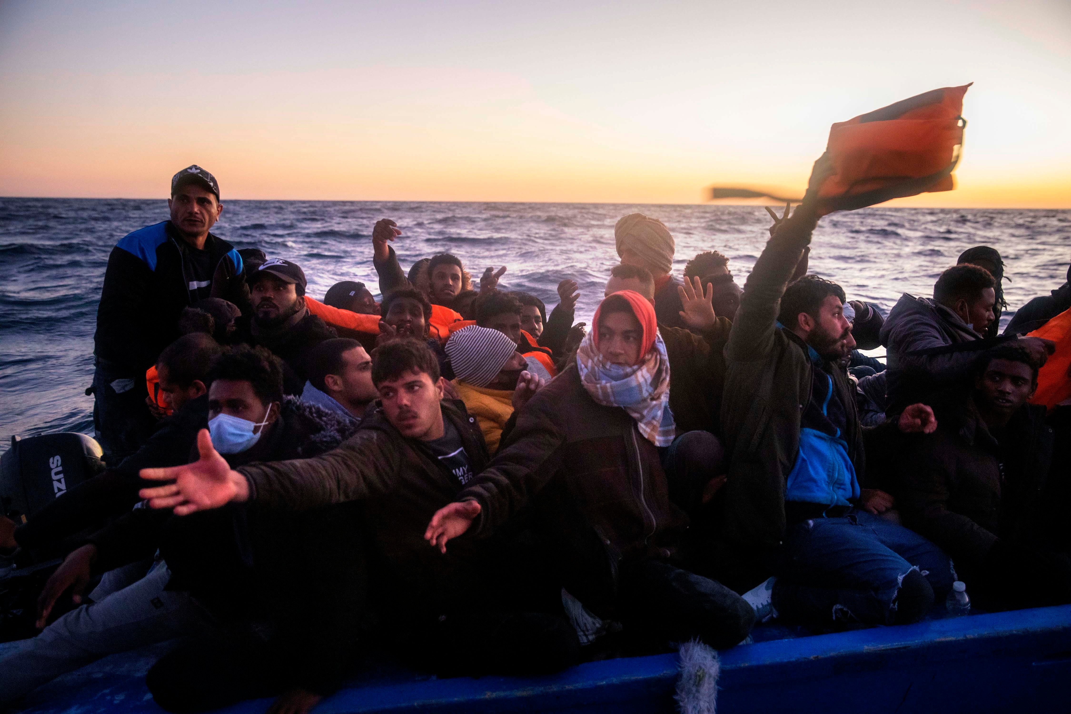 Migrants and refugees on an overcrowded rubber boat during a rescue by the Spanish NGO Open Arms in the Mediterranean Sea, Feb. 12, 2021