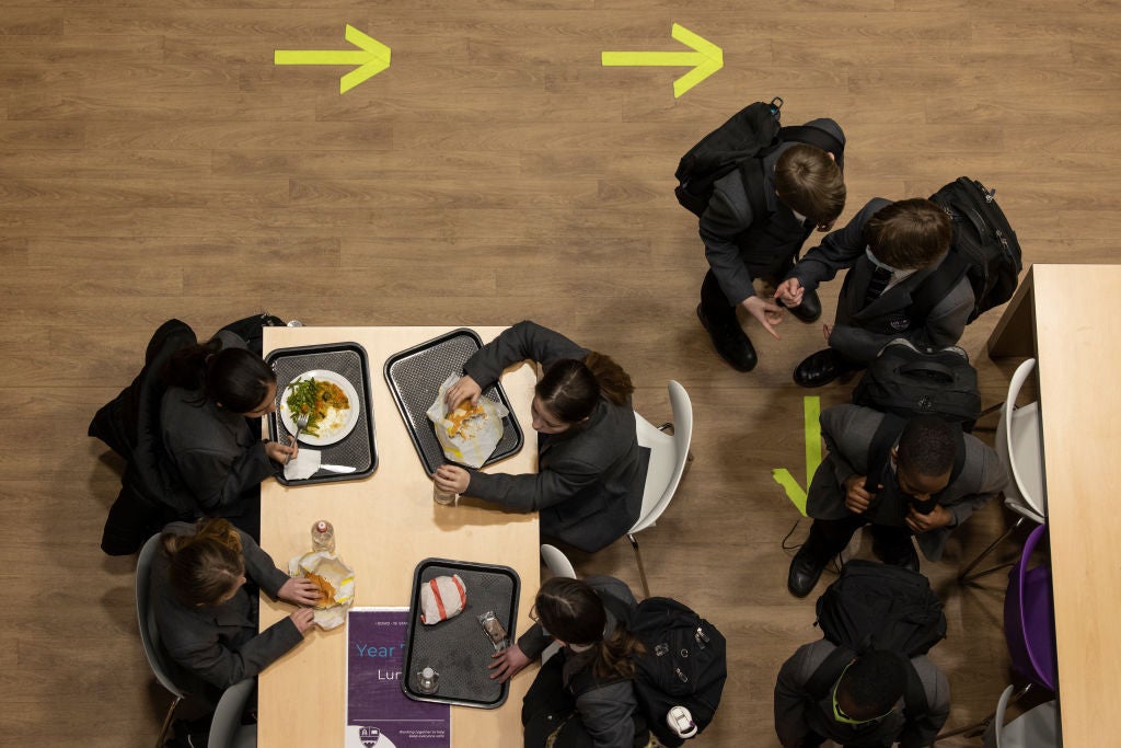 Students eat lunch at Chertsey High School on March 09, 2021 in Chertsey, United Kingdom. 