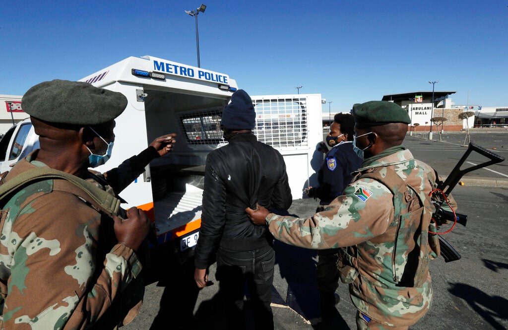 A man suspected of looting is arrested at a shopping mall in Soweto, near Johannesburg, Tuesday July 13, 2021. 