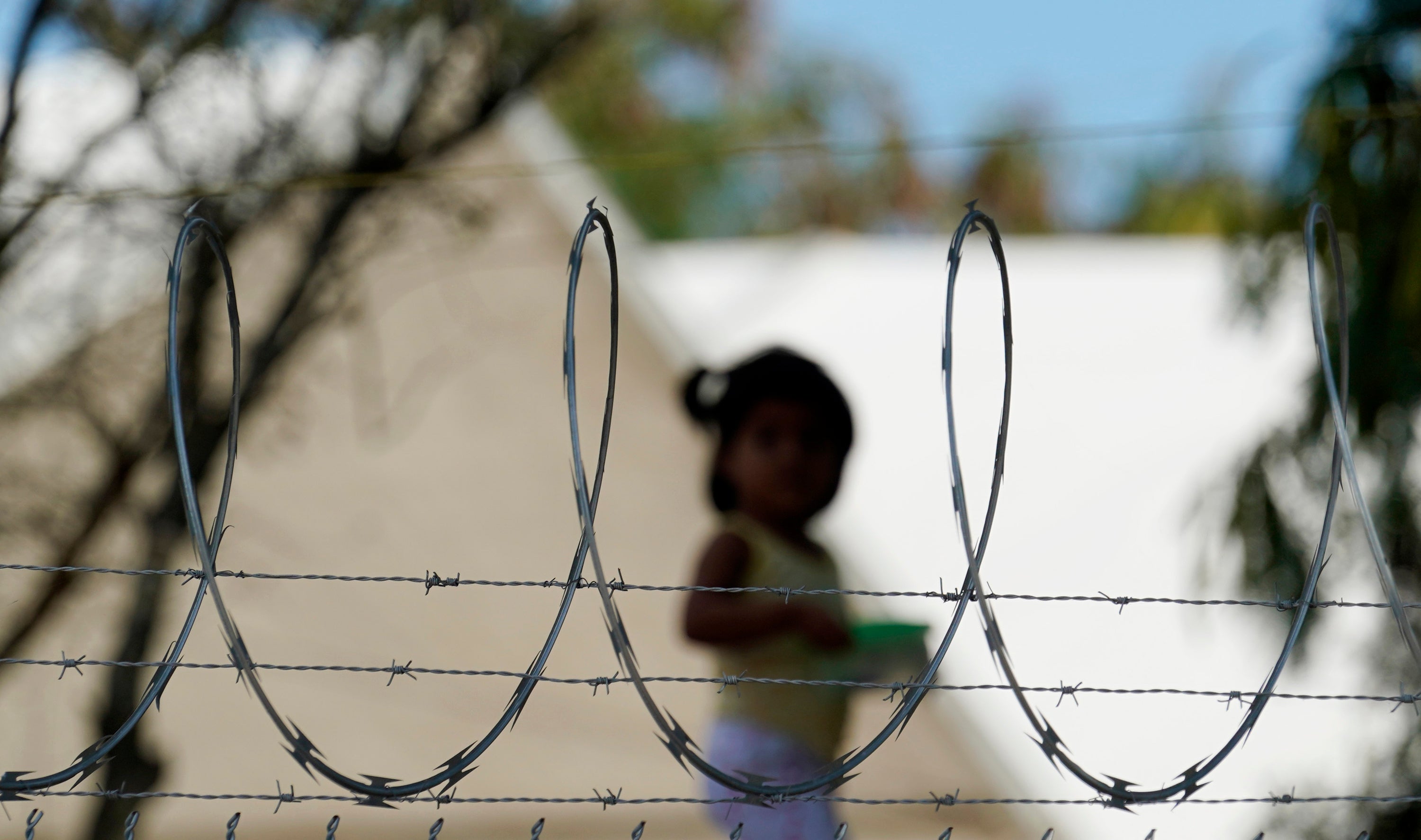 A child plays at a camp for US asylum seekers in Matamoros, Mexico, a city south of the Texas border where hundreds have been waiting under the "Remain in Mexico" program, on November 18, 2020.