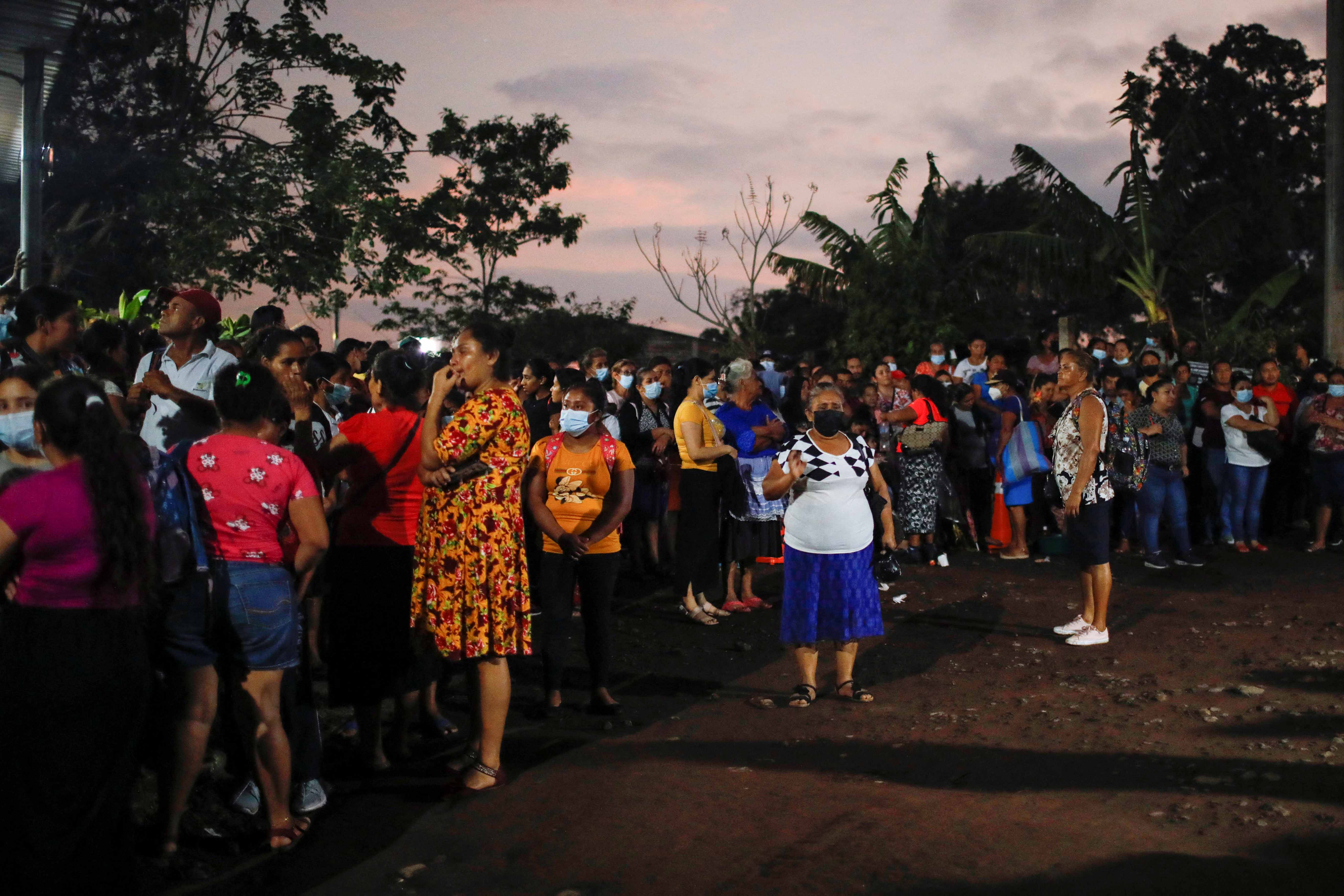People wait for news of the release of relatives detained during the state of emergency in El Salvador, at the security perimeter of the Izalco prison in Izalco, El Salvador, on April 28, 2022.