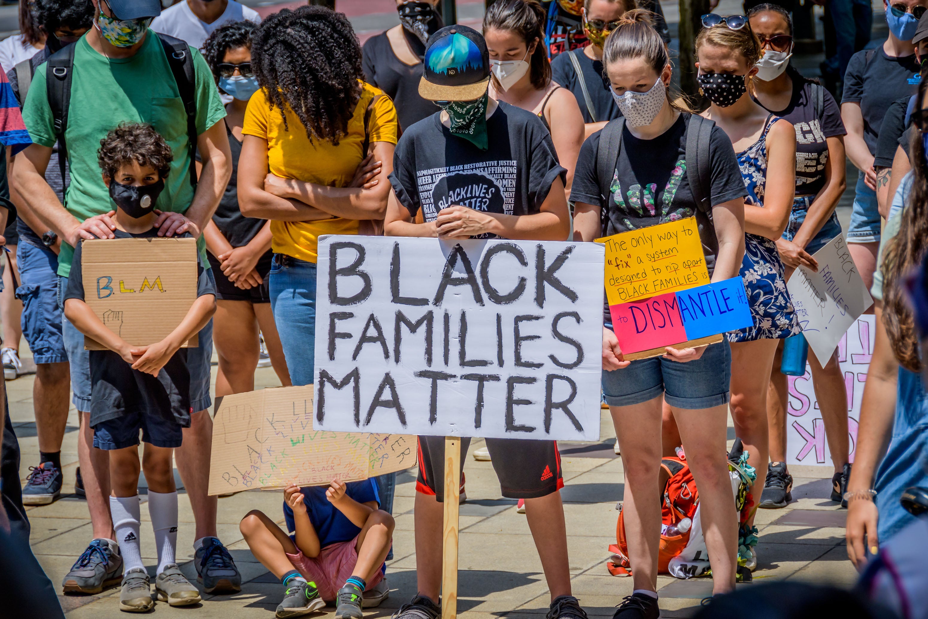 Protesters hold signs at a demonstration in Brooklyn
