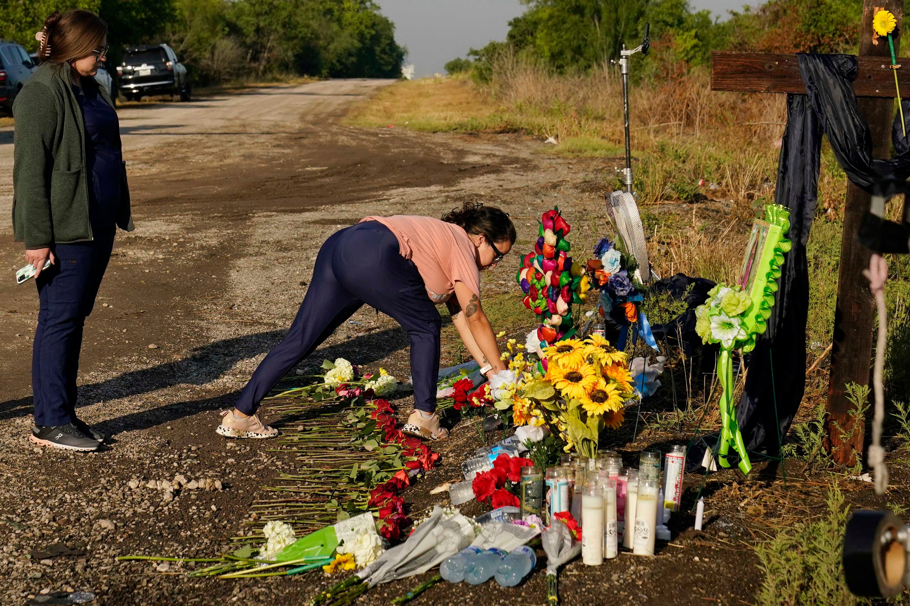 Mourners lay flowers at a makeshift memorial