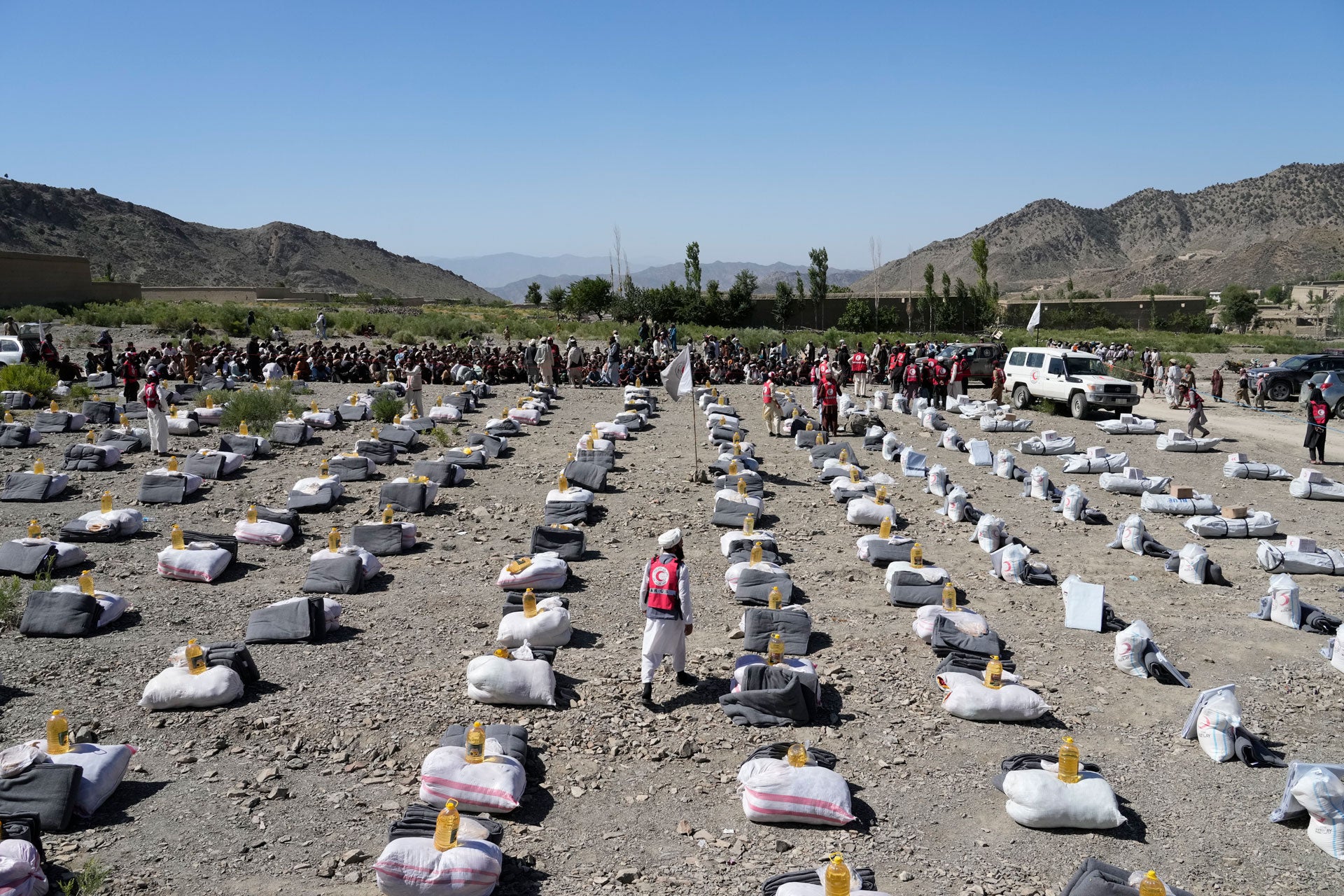 Humanitarian aid is lined up for distribution after an earthquake in Gayan village