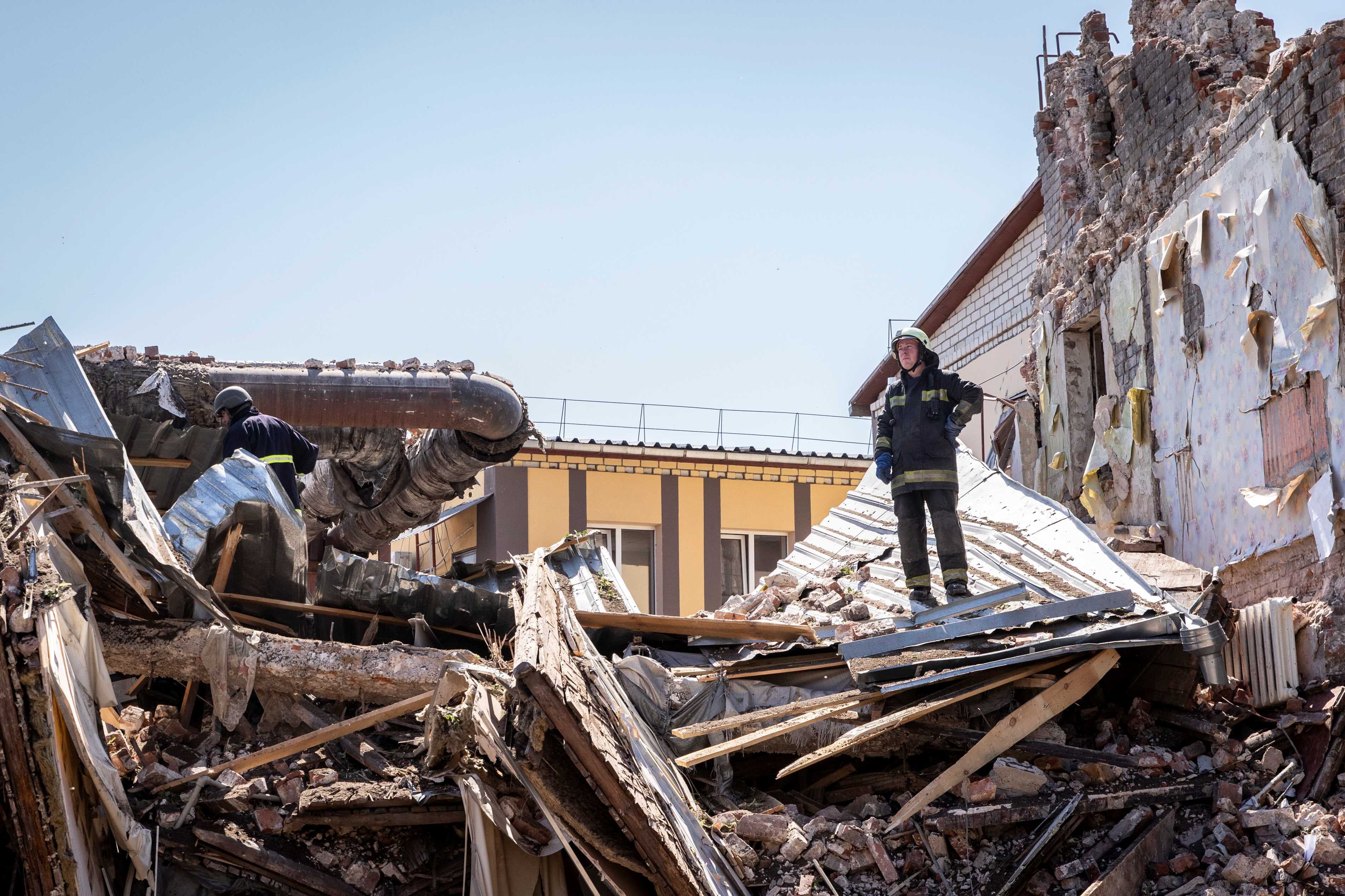 A fireman stands in the ruins of a building destroyed by a Russian cruise missile, which also injured several civilians, in Kharkiv, Ukraine, July 9, 2022.