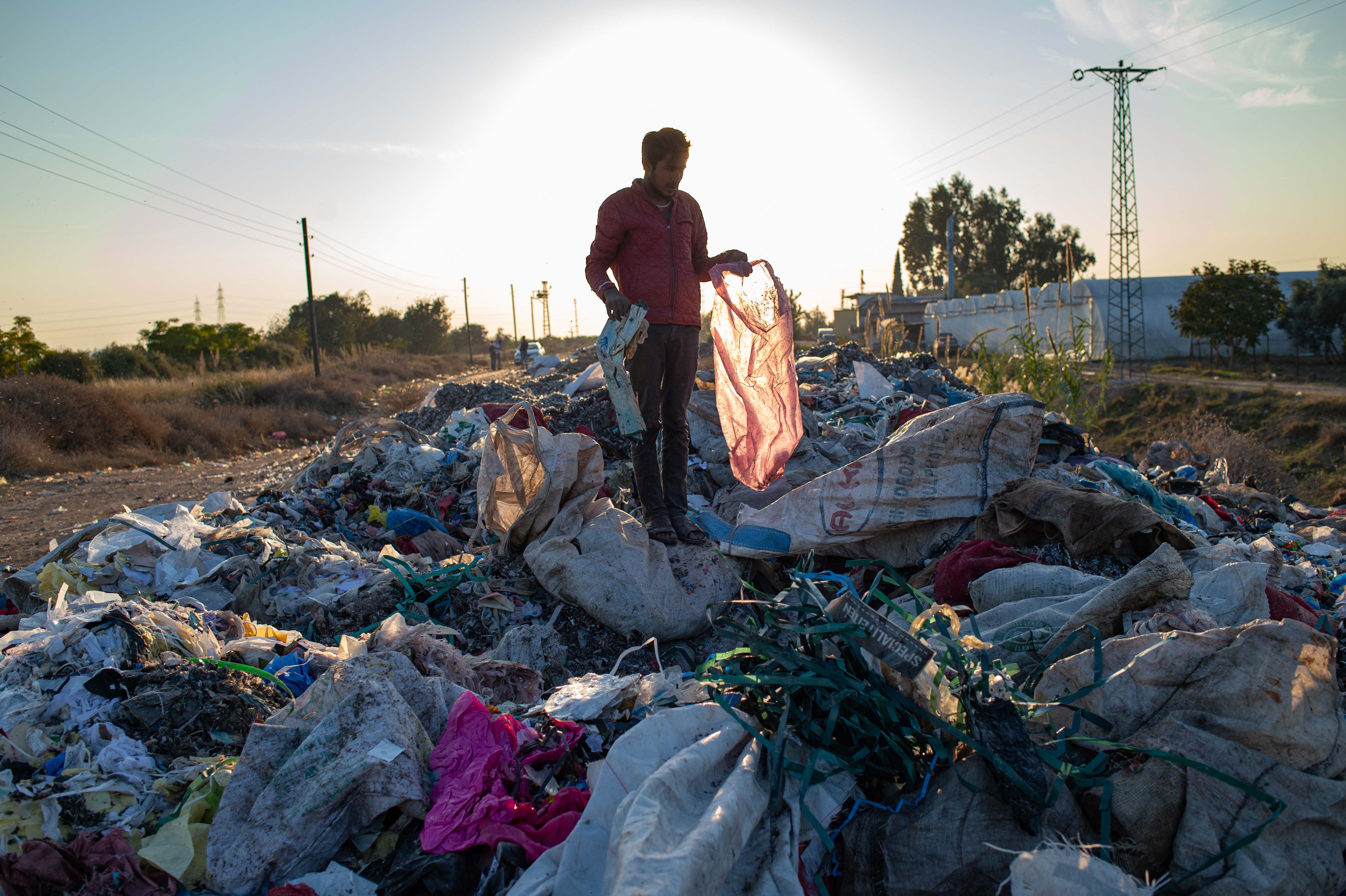 A man collects items from an illegal dump on November 29, 2020 in Adana, southern Turkey.
