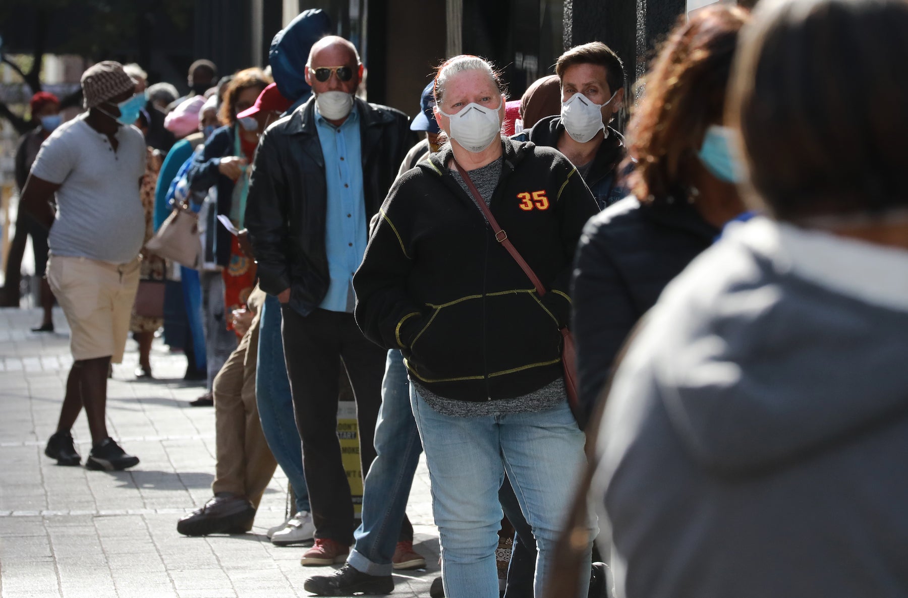People standing in line to receive benefits at a South African Social Security Agency building in Cape Town, South Africa.