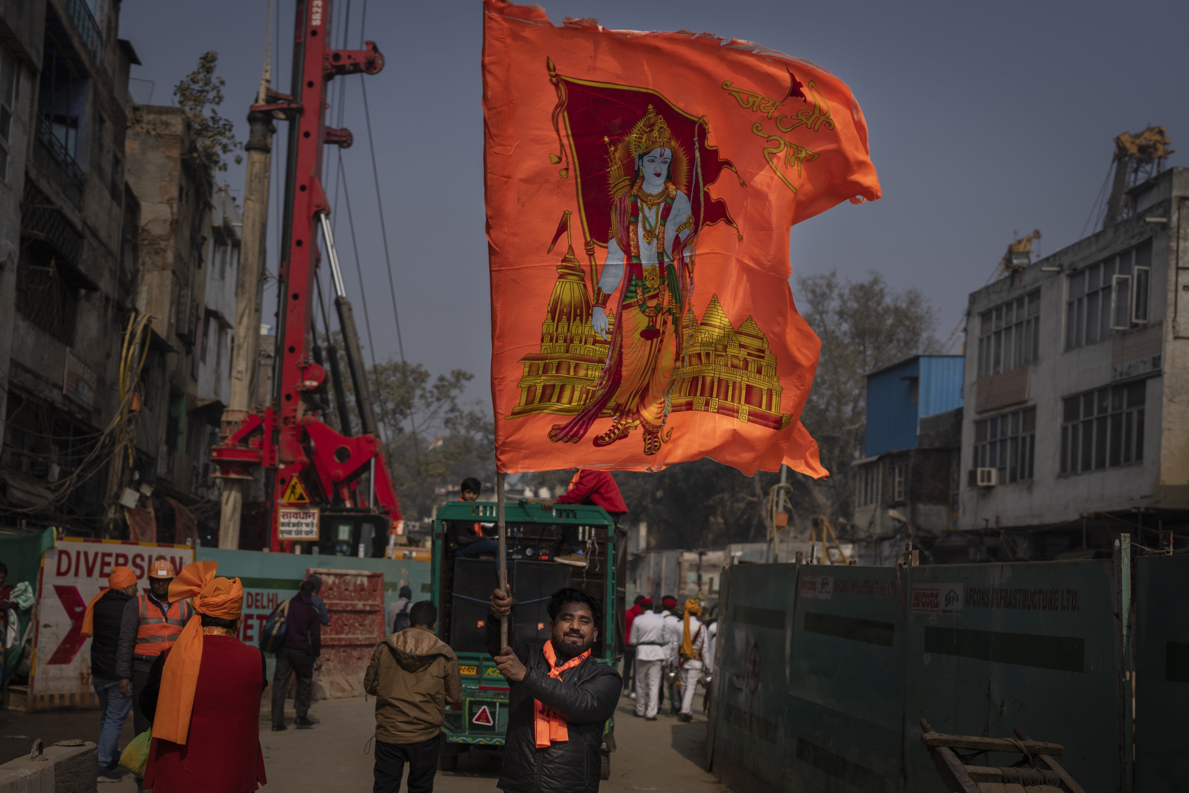 A man waves a flag with the Hindu god Ram to celebrate the opening of the Ram Temple in Ayodhya city, India, January 16, 2024.