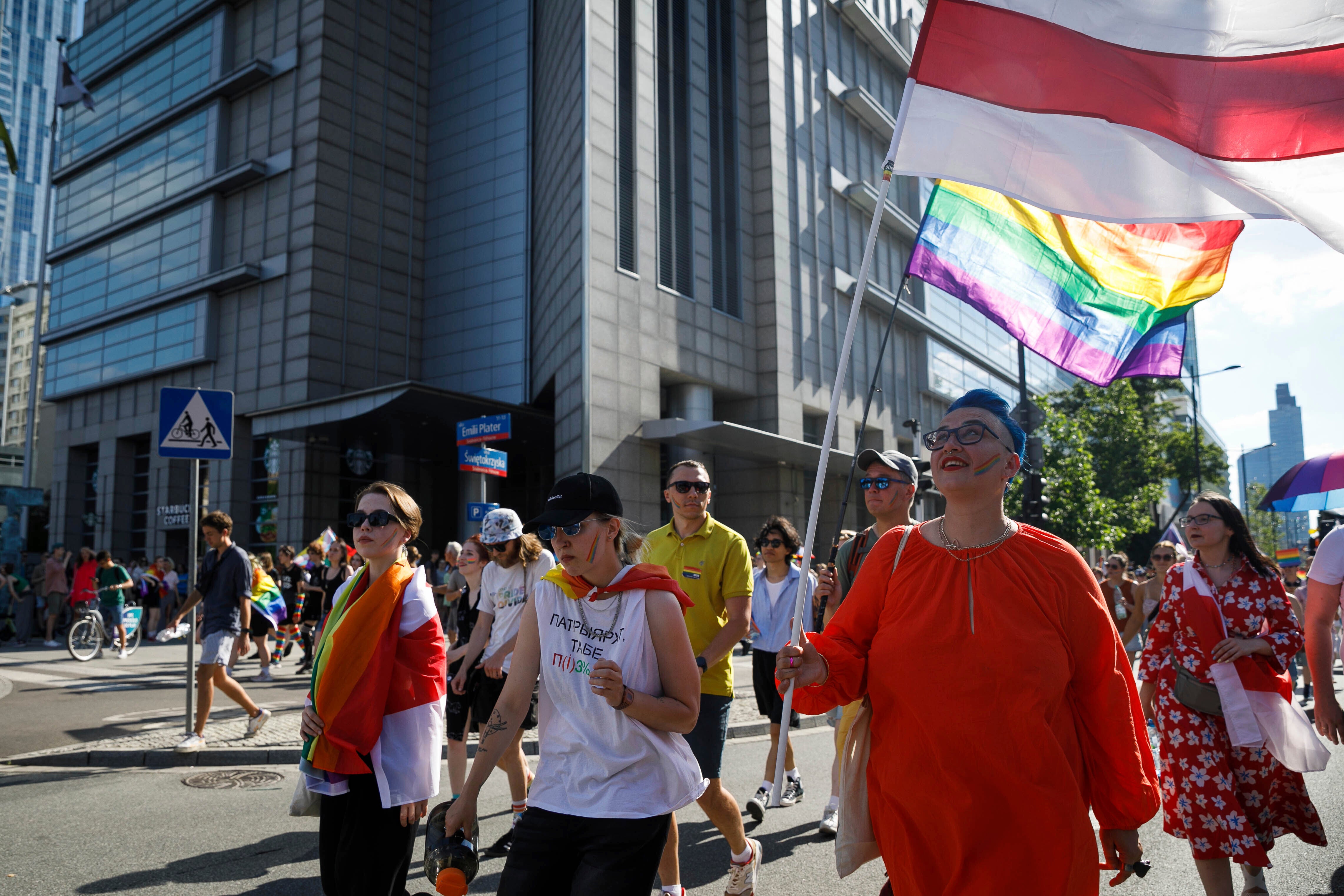 Belarusian LGBTQ activists with white-red-white flags participate in the Warsaw Equality Parade, June 25, 2022.