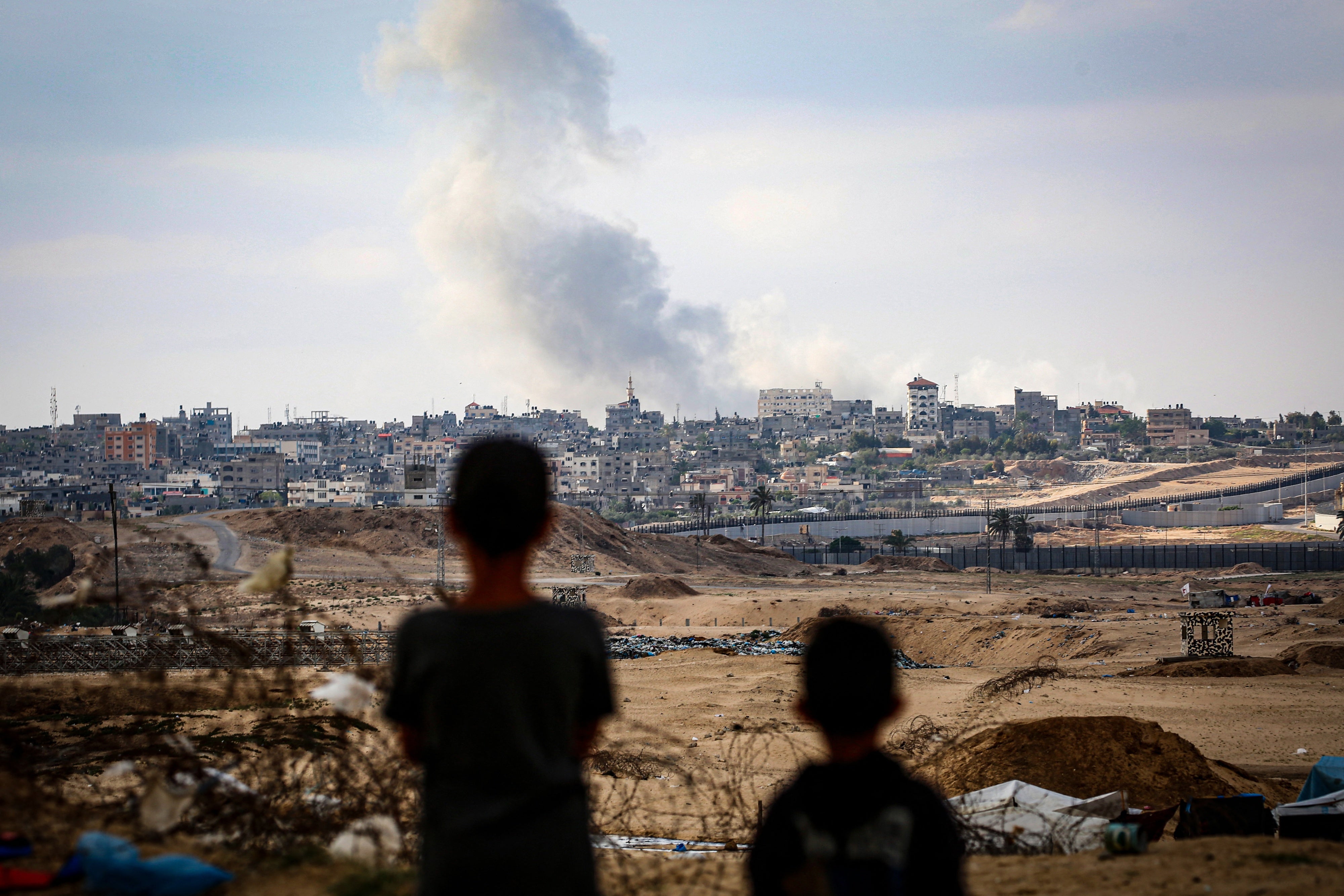 Children watch airstrikes east of Rafah in the southern Gaza Strip on May 13, 2024. 