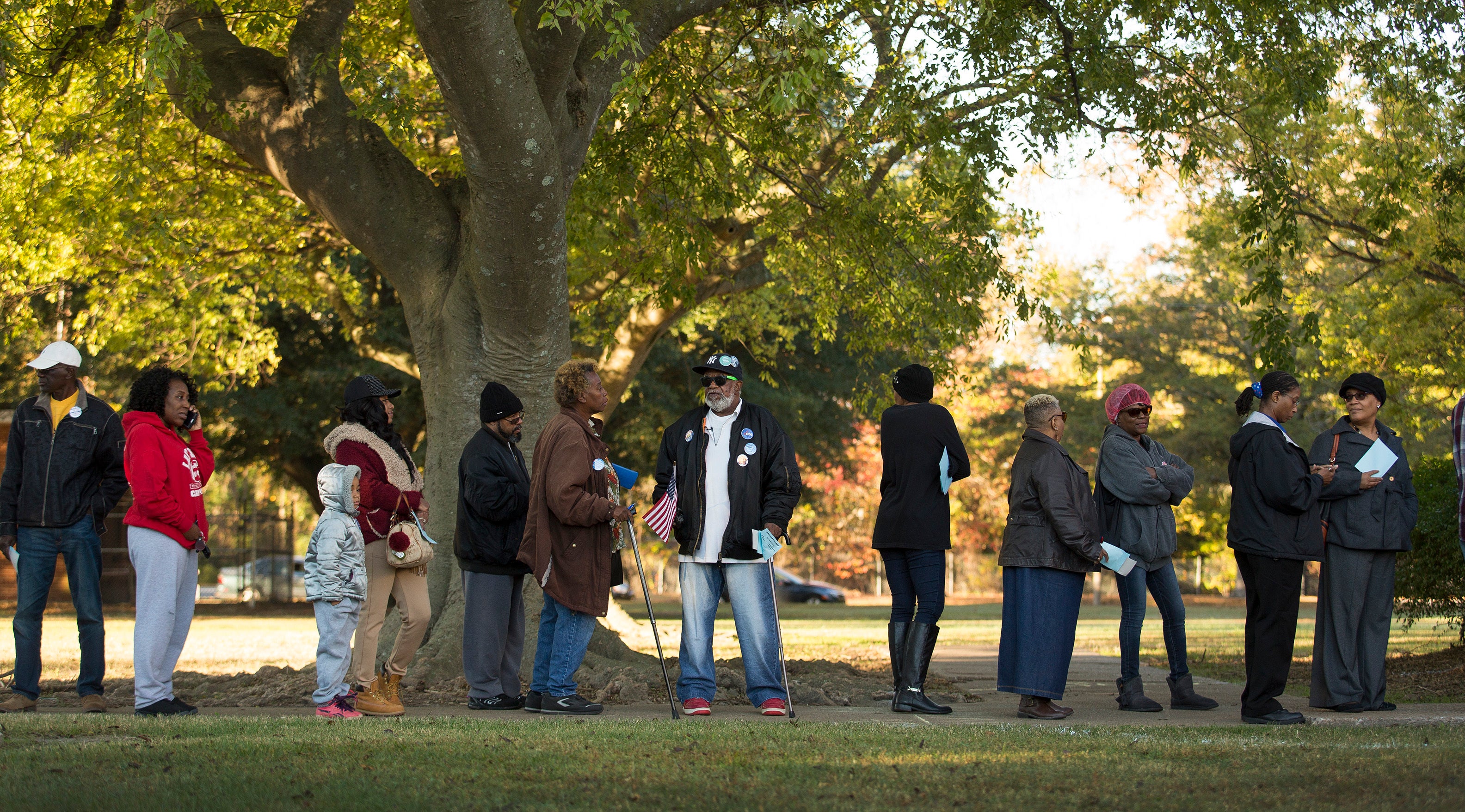 People stand in line to vote