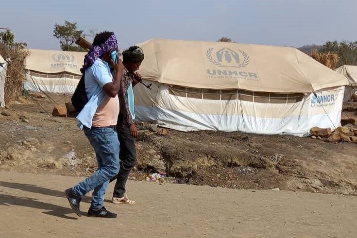 Two men walking in Kumer camp