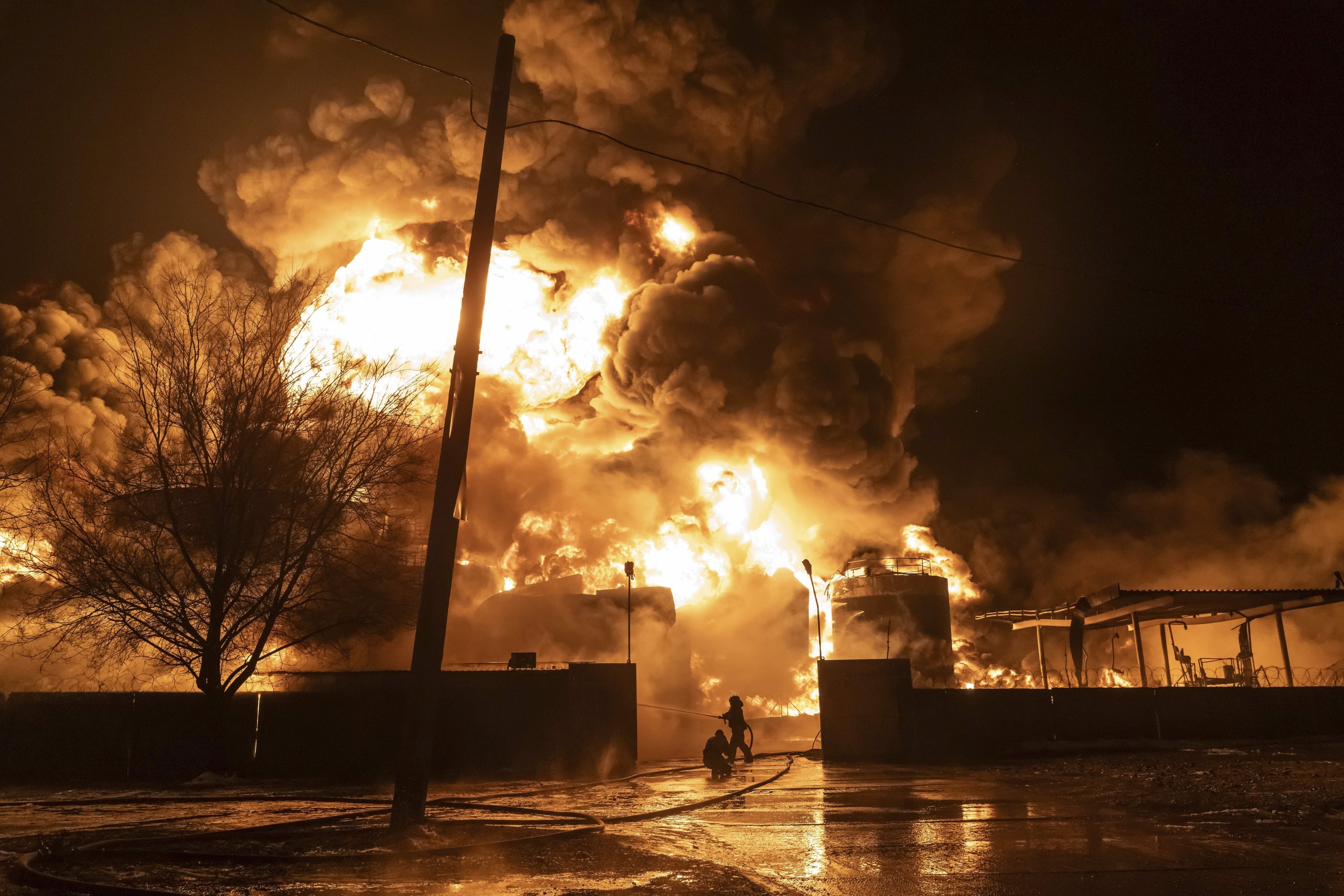 Firefighters extinguish a fire after a Russian attack on a neighborhood in Kharkiv, Ukraine, February 10, 2024.