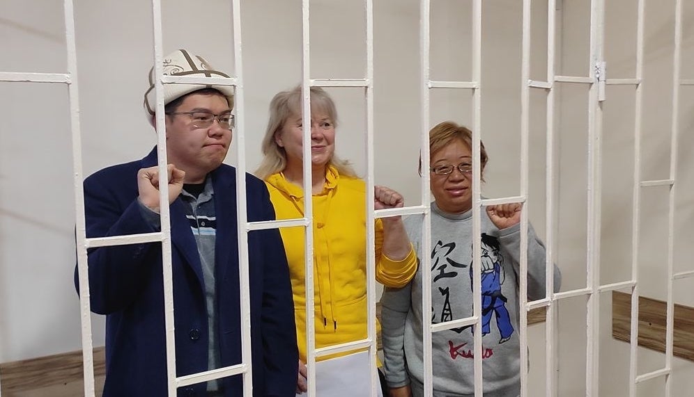 Kyrgyzstan Social Democrats party leader Temirlan Sultanbekov (L), chief campaigner Irina Karamushkina (C), and party member Roza Tyurksever after being detained in Bishkek on November 15, 2024. 