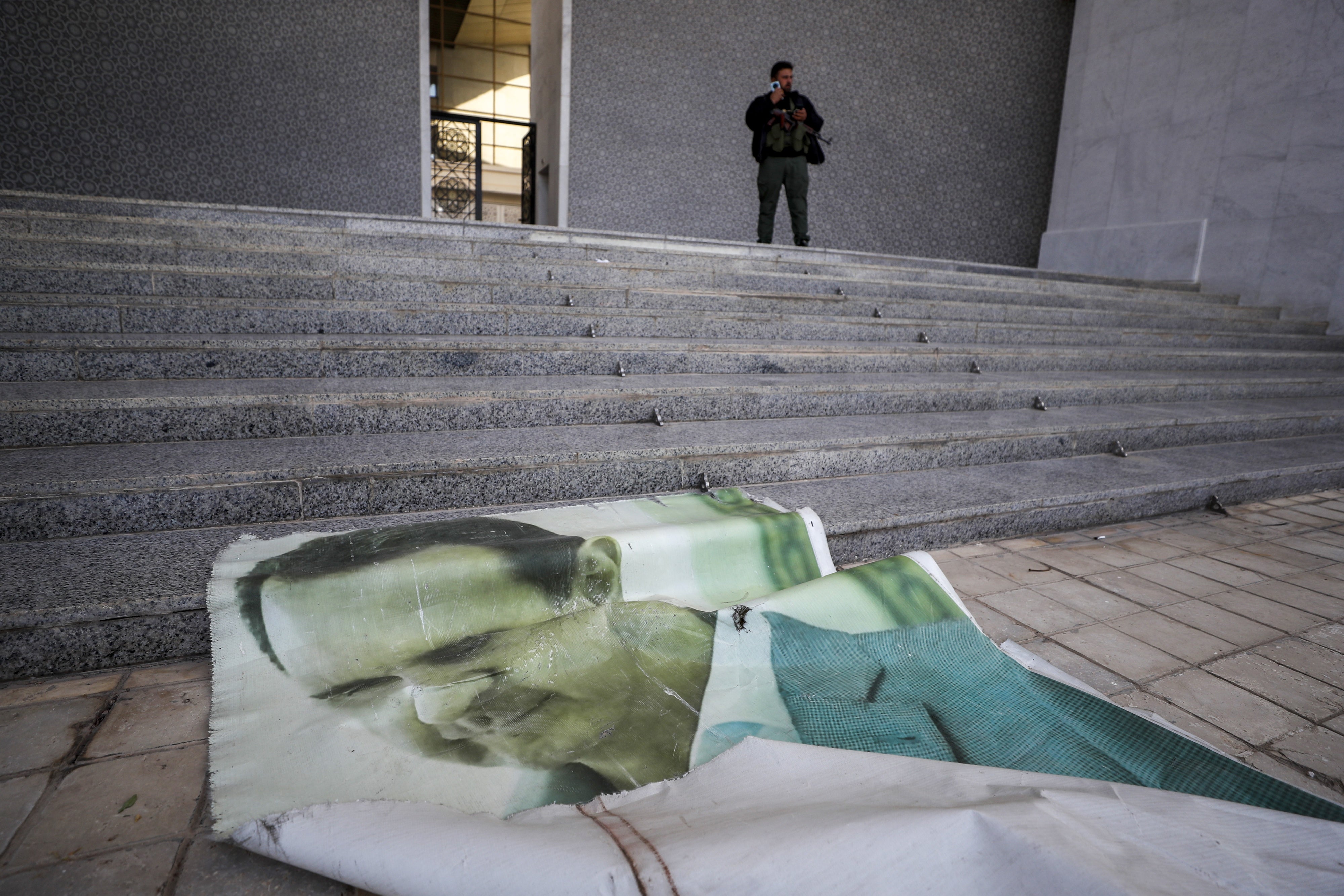 Photo of Bashar al-Assad lies on the floor of the presidential palace in Damascus