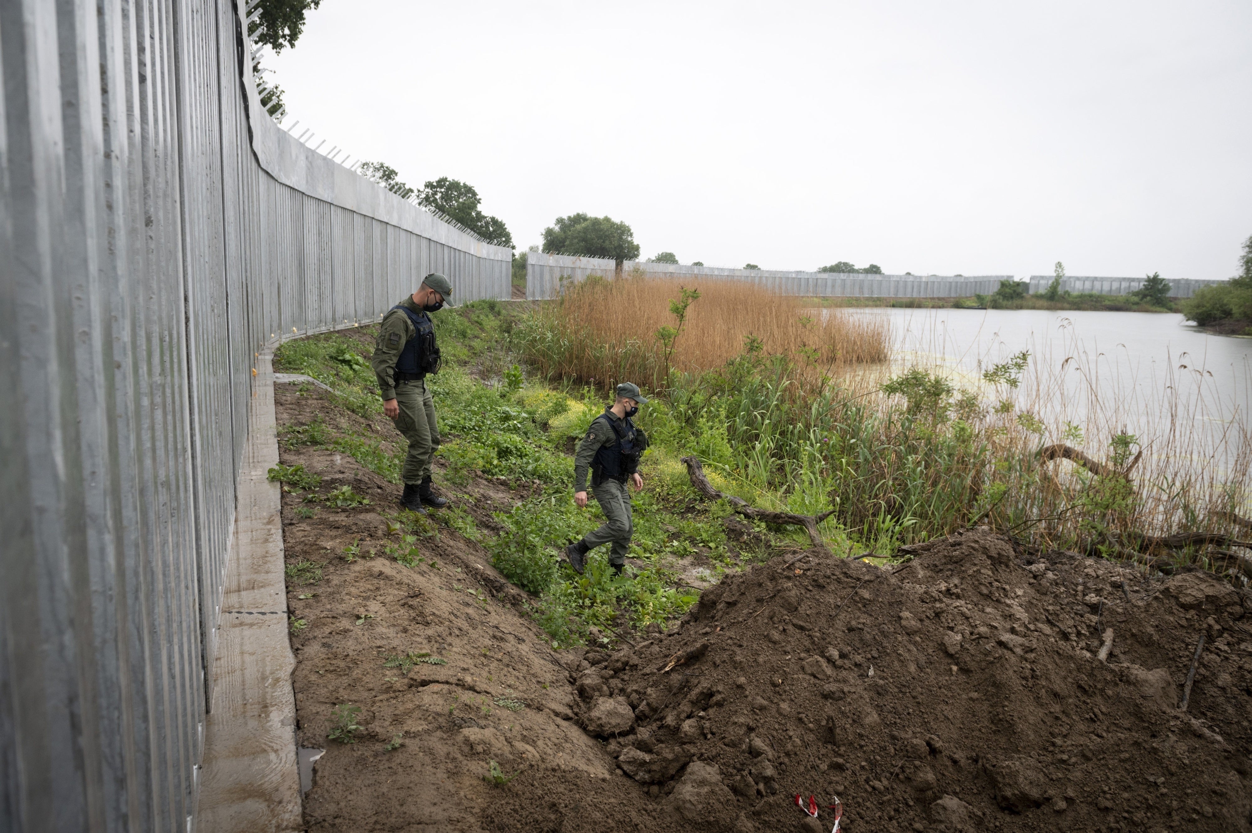  Police patrol along a steel wall at Evros river, near the village of Poros, at the Greek - Turkish border, Greece, May 21, 2021.