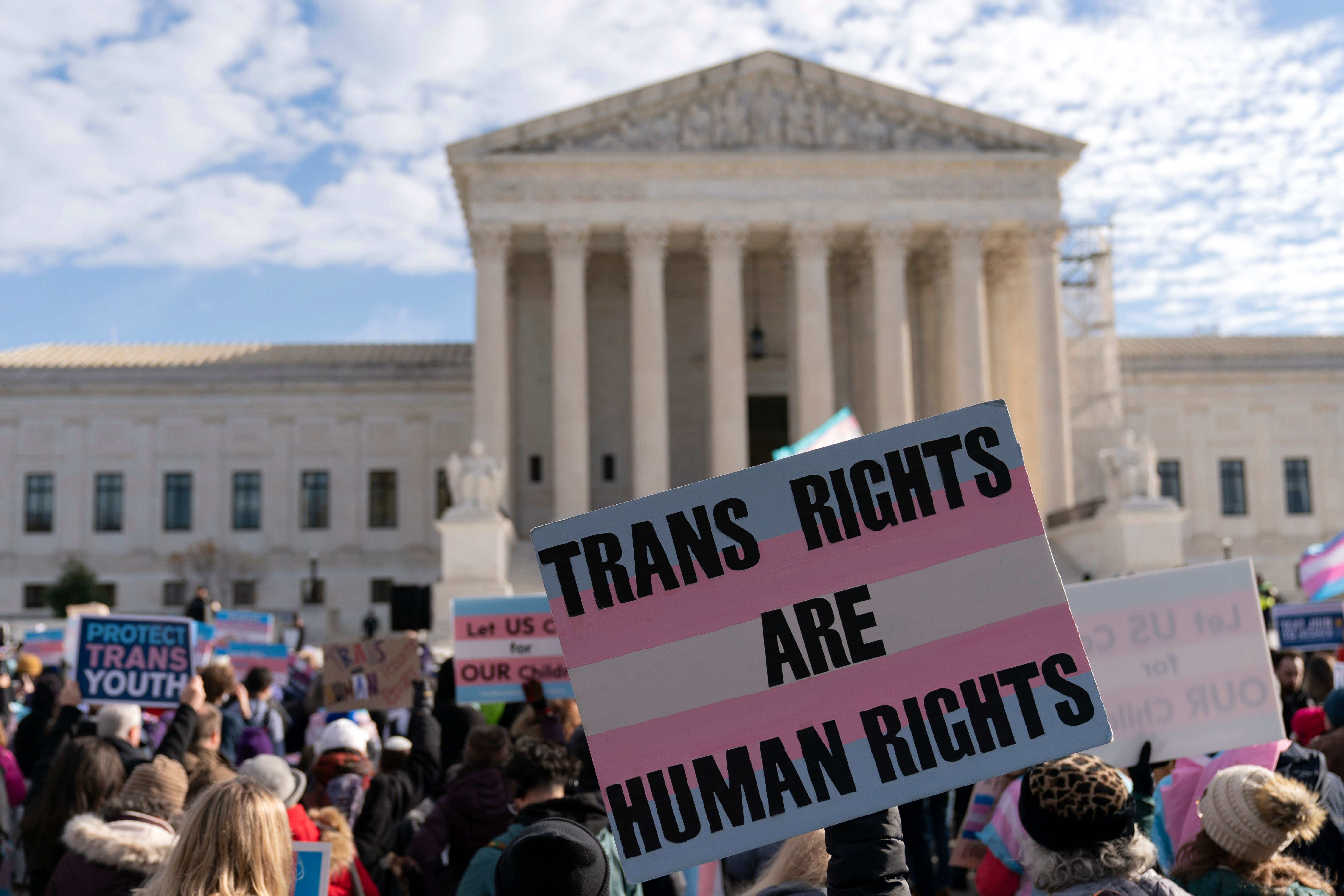 Transgender rights supporters rally outside of the Supreme Court in Washington, DC, US,  December 4, 2024.