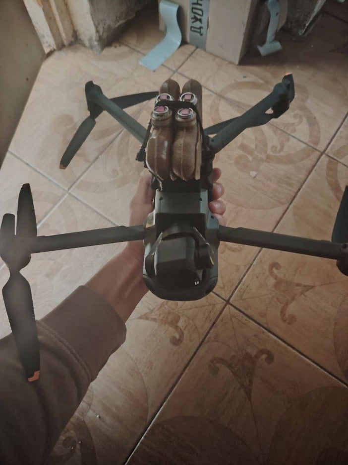 four PFM antipersonnel landmines attached to the underside of a DJI drone