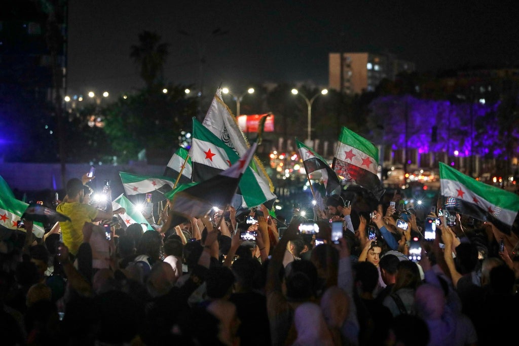 Syrians celebrate in Umayyad Square after U.S. President Donald Trump announced plans to ease sanctions on Syria in Damascus, Syria, Tuesday, May 13, 2025.