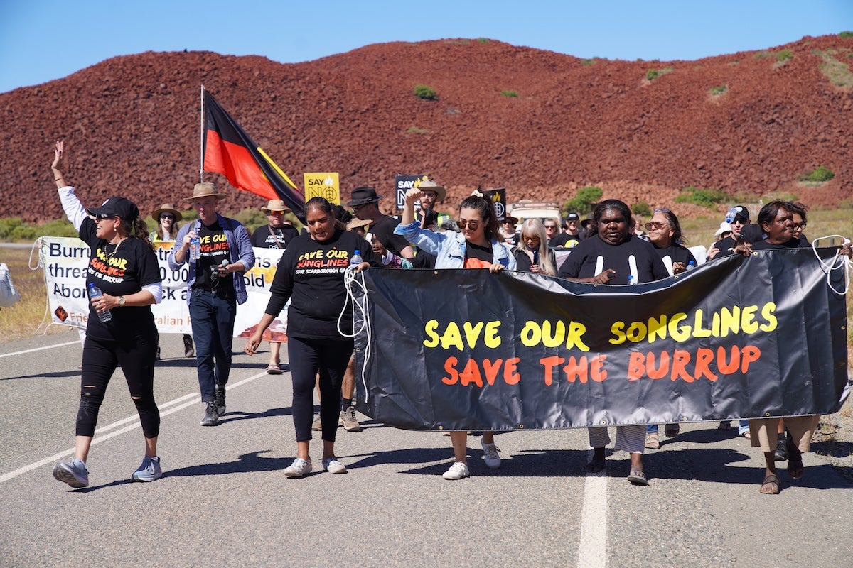 Protesters march near the site of the oil and gas project