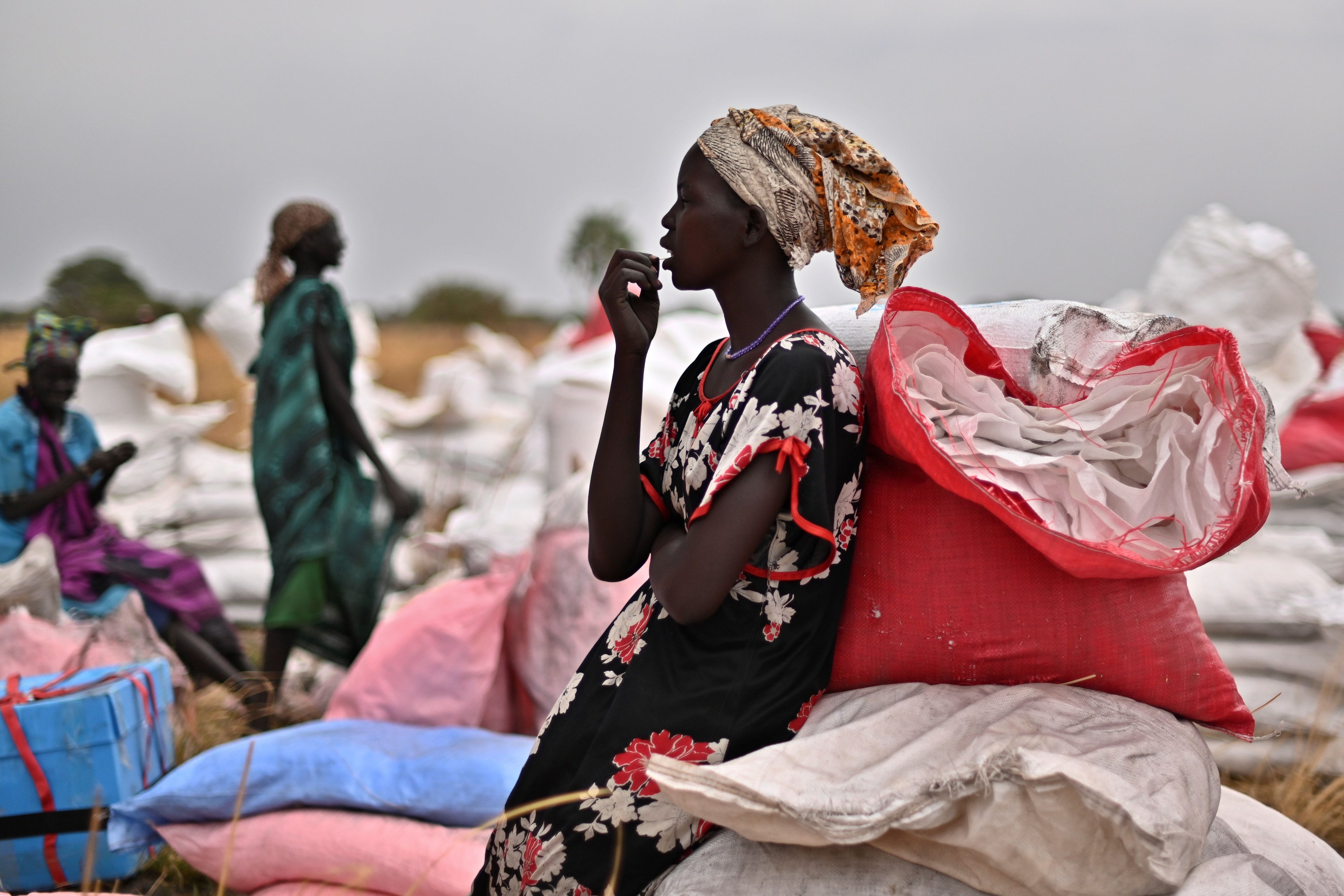 A villager who had volunteered to fetch gunny bags containing food rations from the site of an air drop takes a break at a village in Ayod county, South Sudan, February 6, 2020.