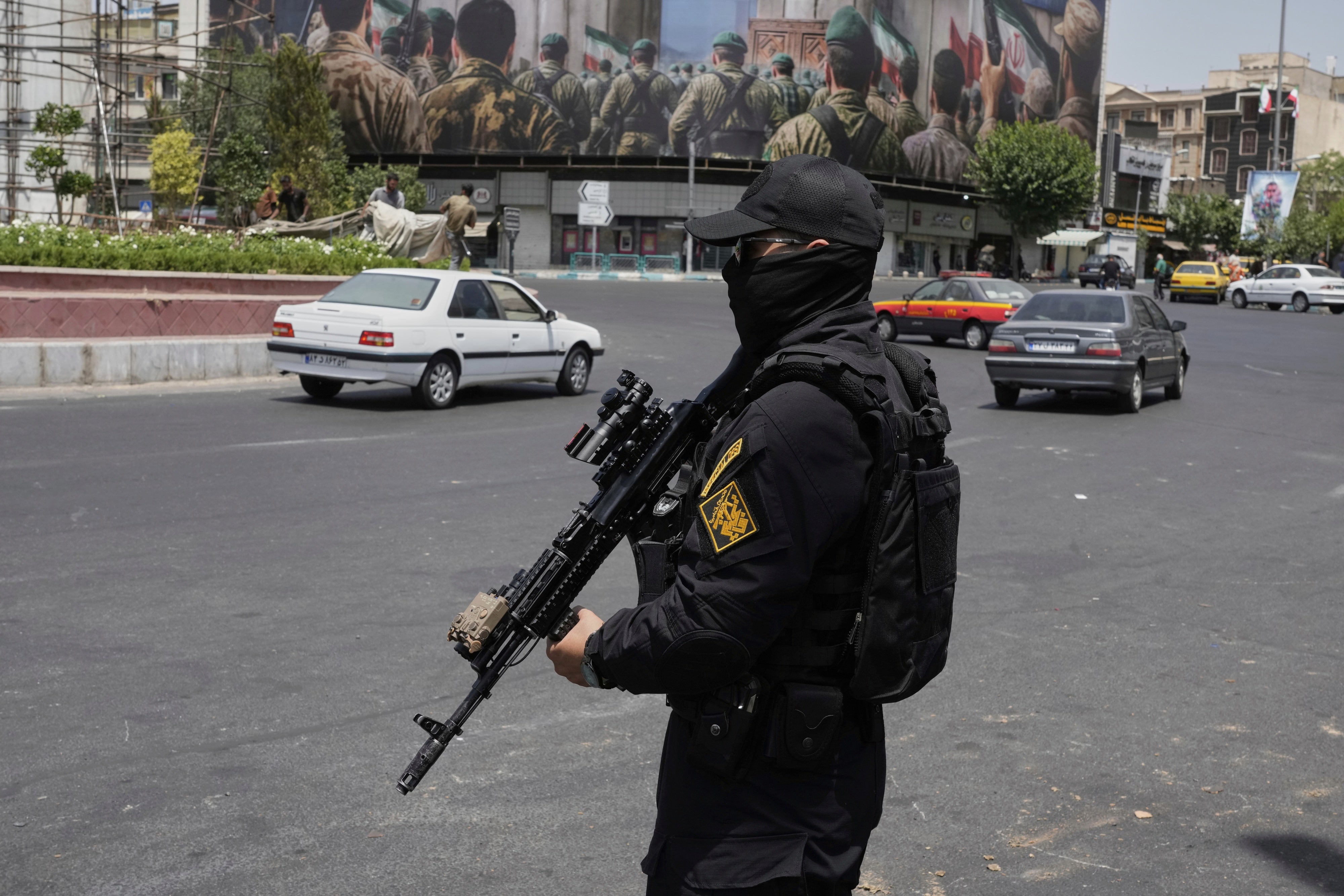 A member of Iran's security forces stands guard at Enqelab square in downtown Tehran, Iran, June 24, 2025.