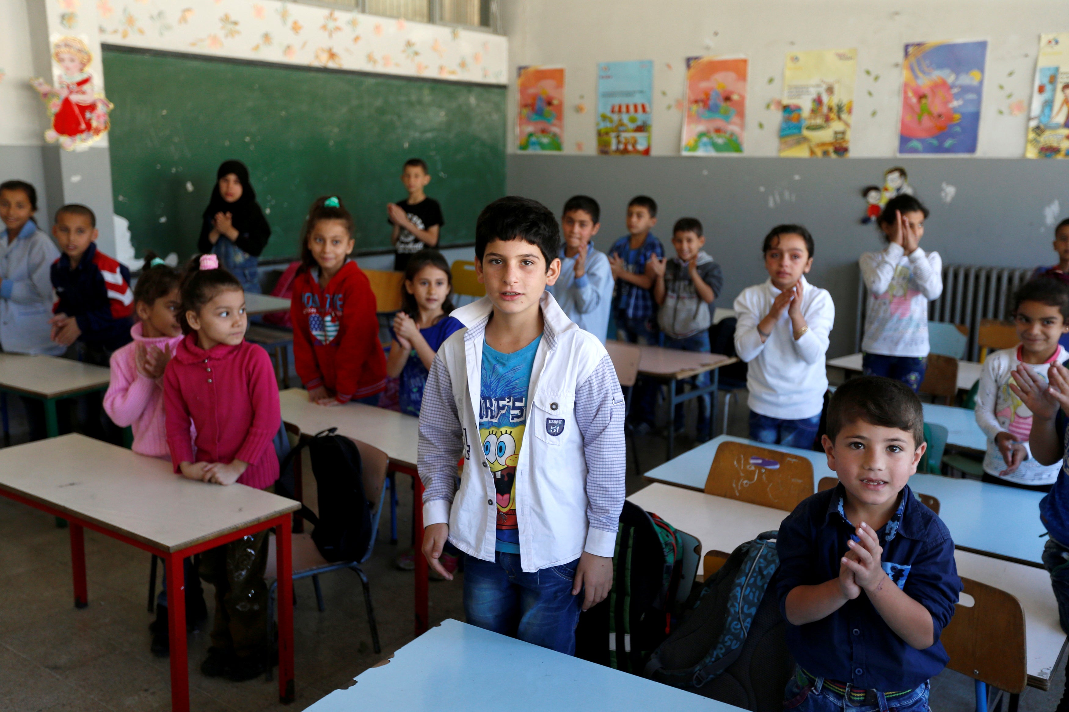Syrian refugee children attend a class at a school in Mount Lebanon, October 7, 2016.