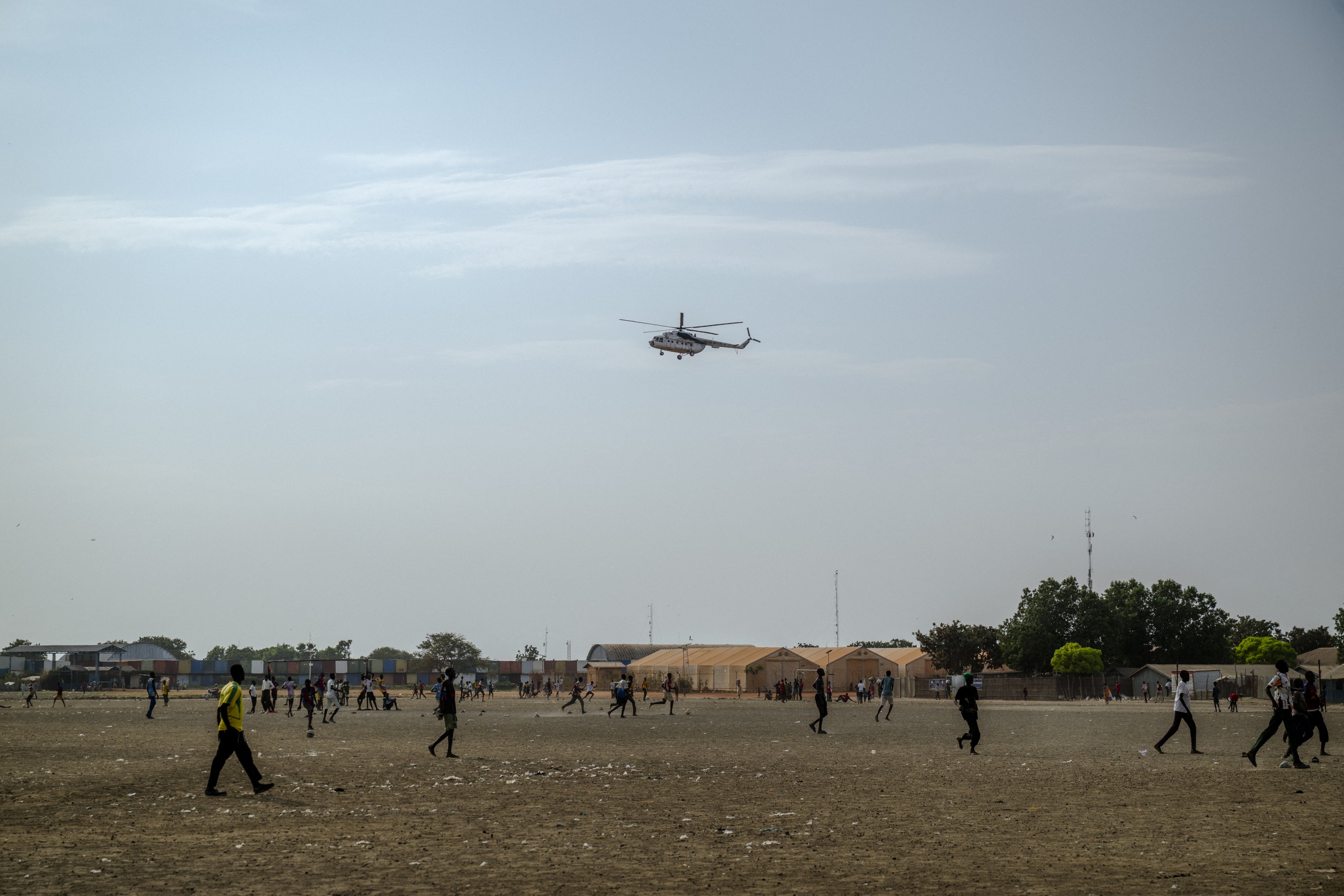 A UN helicopter performs a routine patrol over the Bentiu internally displaced persons camp in Unity State, South Sudan, on November 4, 2025.