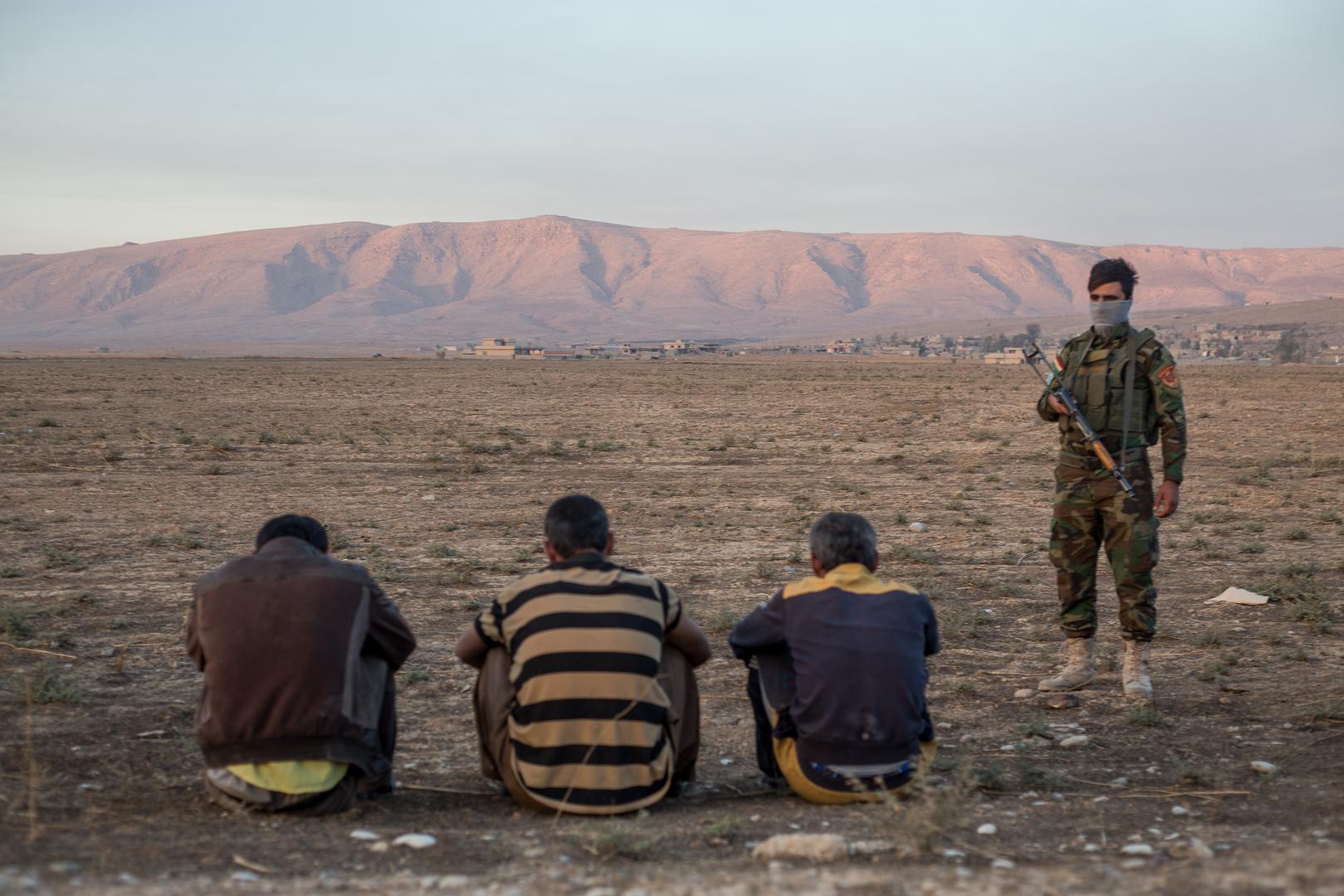 Three suspected ISIS members who travelled alongside families escaping areas around Mosul recently retaken from the group are held by KRG’s security forces at a checkpoint east of the city. November 4, 2016. 