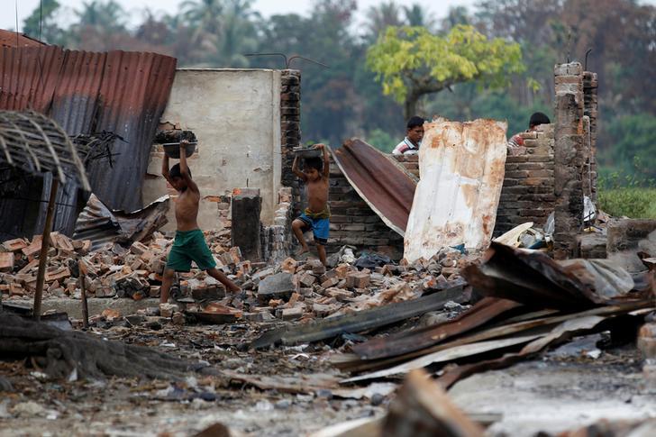 Children recycle goods from the ruins of a market which was set on fire at a Rohingya village outside Maungdaw in Rakhine state, Burma, on October 27, 2016.