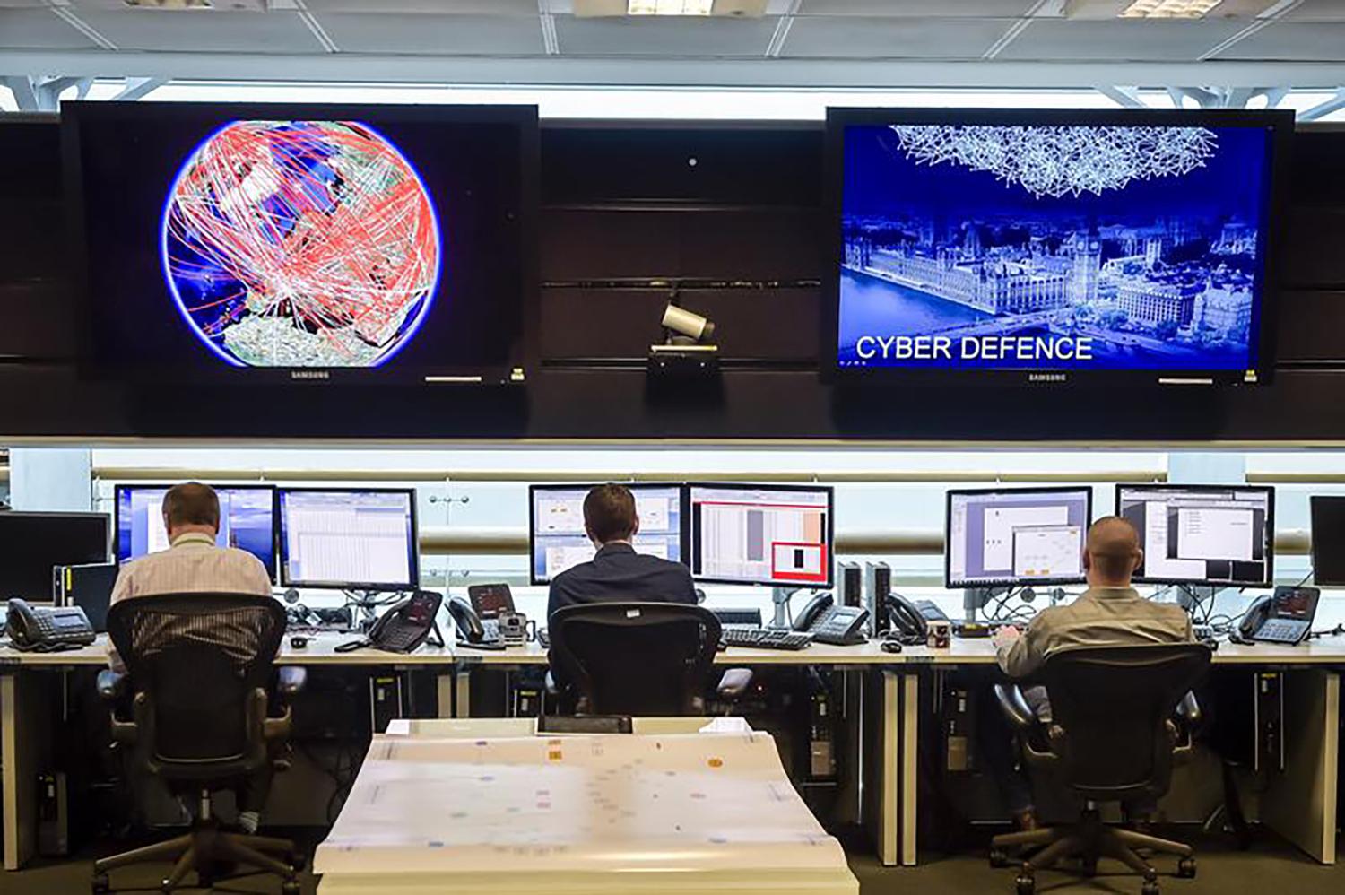 People sit at computers inside GCHQ, Britain's intelligence agency, in Cheltenham, UK, November 17, 2015.