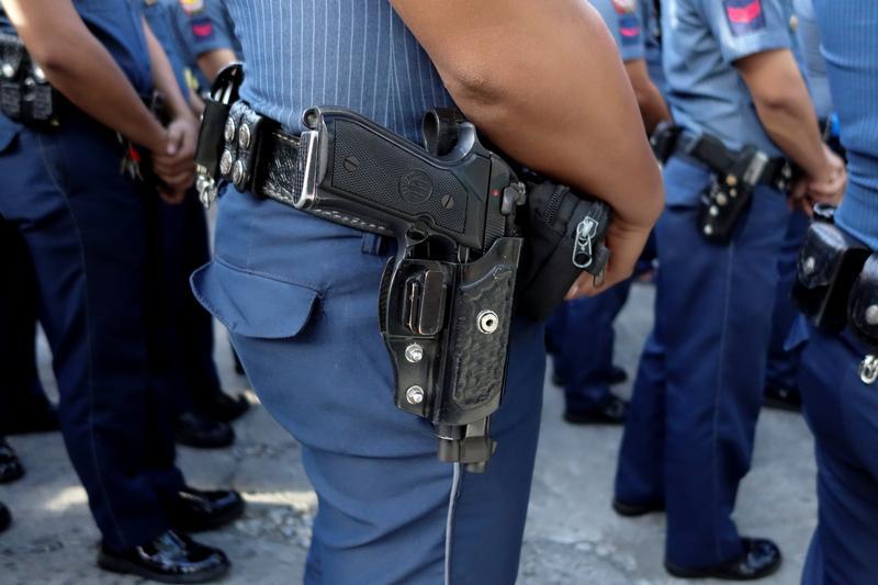 Police line up for a flag-raising ceremony outside a station in Quezon City Police District in Manila, Philippines April 3, 2017. Picture taken on April 3, 2017.