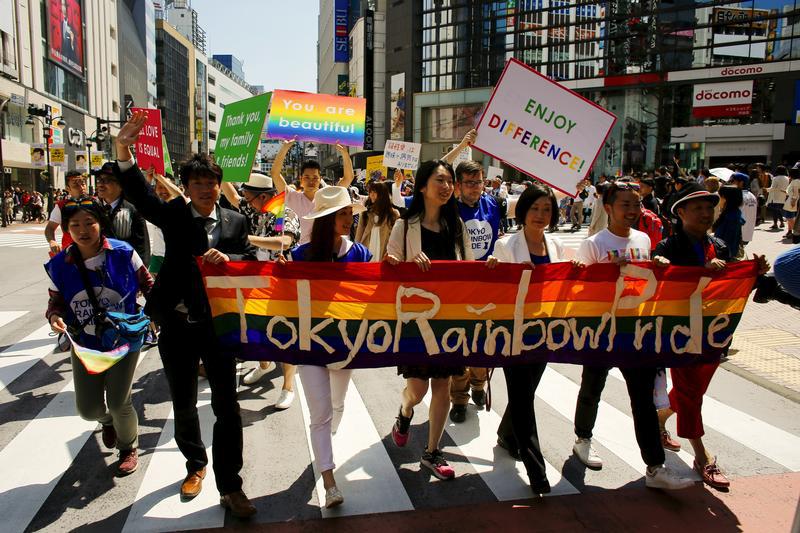 Participants hold a banner as they march during the Tokyo Rainbow Pride parade in Tokyo April 26, 2015.