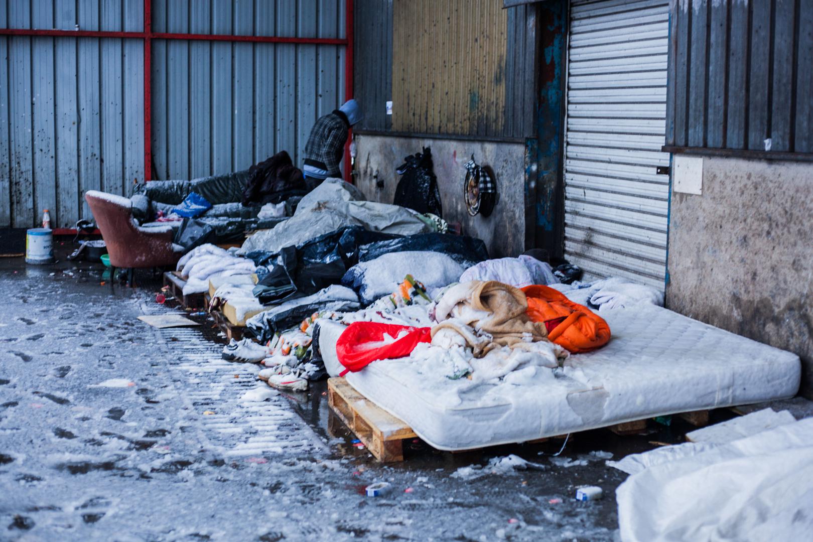 Asylum seekers and other migrants sleep outside in the snow, Calais, France, December 11, 2017. 