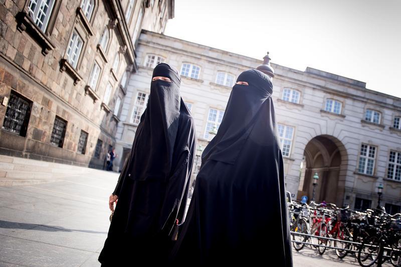 Women in niqab are pictured after the Danish Parliament banned the wearing of face veils in public, at Christiansborg Palace in Copenhagen, Denmark, May 31, 2018.