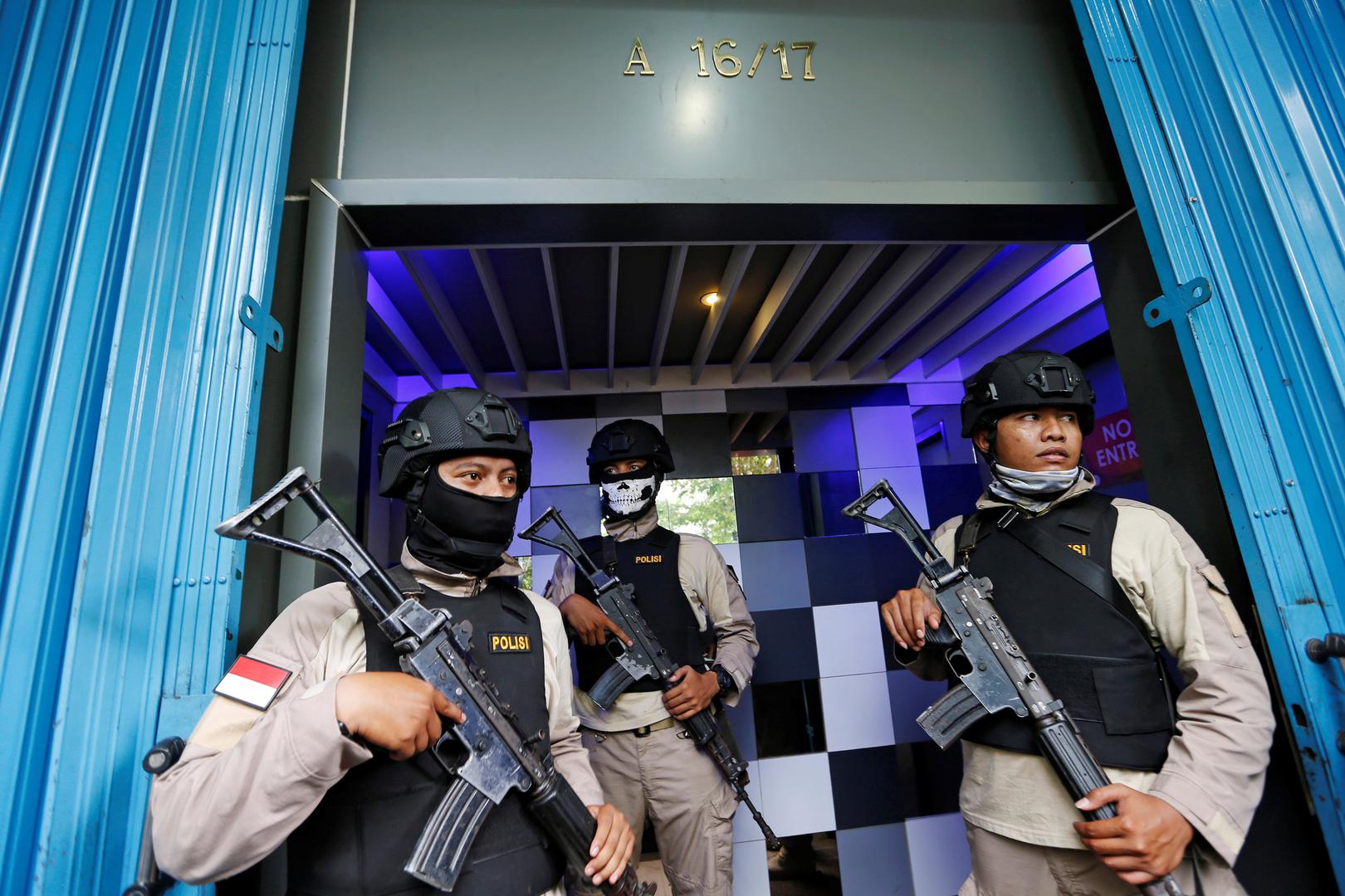 Police officers guard the entry of the T1 night club in Jakarta on October 9, 2017, after they raided it and arrested 10 people for alleged violations of the anti-pornography law. 