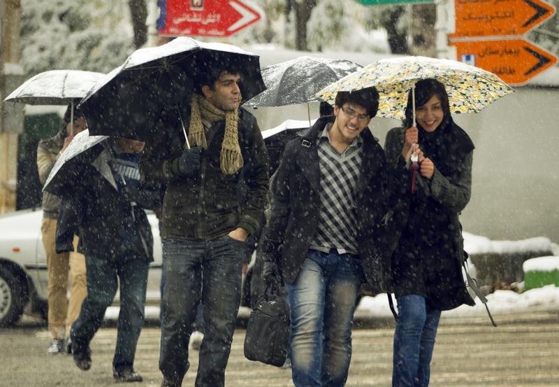 University students cross a street during a snow storm in Tehran November 8, 2010. © 2010 Reuters/Caren Firouz