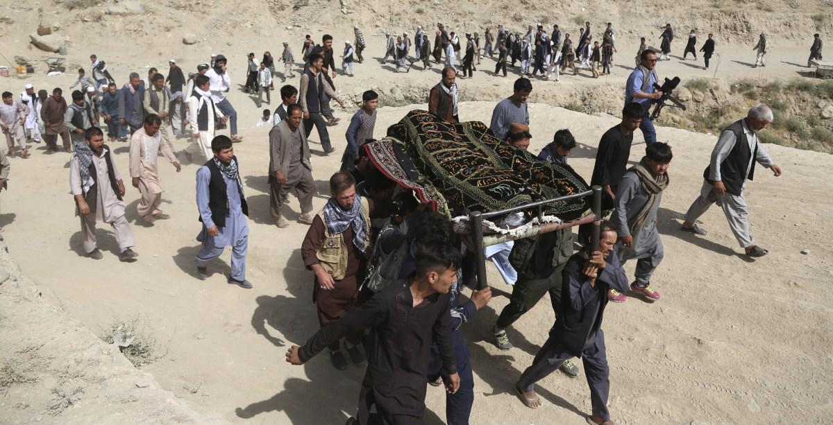 Men carry the coffin of a relative who died in the suicide bombing at Mawoud Academy in Kabul, Afghanistan, August 16, 2018.