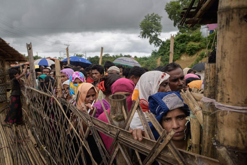 Rohingya refugees line up at an aid relief distribution center at the Balukhali refugee camp near Cox’s Bazar, Bangladesh, August 12, 2018.