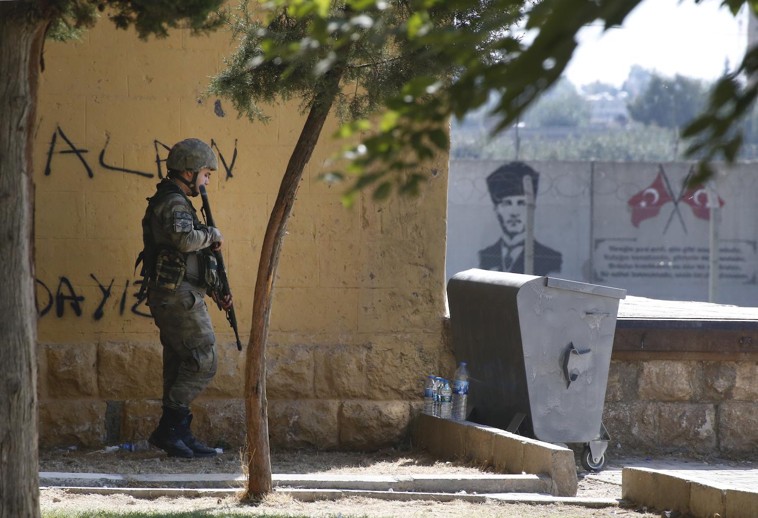 A Turkish soldier stands at the border with Syria in Akcakale, Sanliurfa province, southeastern Turkey, Thursday, Oct. 10, 2019. 