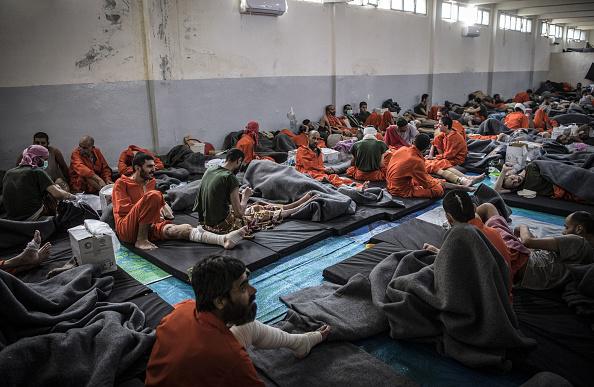 Men, suspected of being affiliated with the Islamic State, gather in a prison cell in the northeastern Syrian city of Hasakeh on October 26, 2019.  