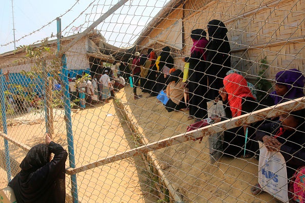 Rohingya refugees wait at a crowded relief distribution point at the Kutupalong refugee camp in Ukhia, Cox's Bazar, Bangladesh, March 24, 2020.