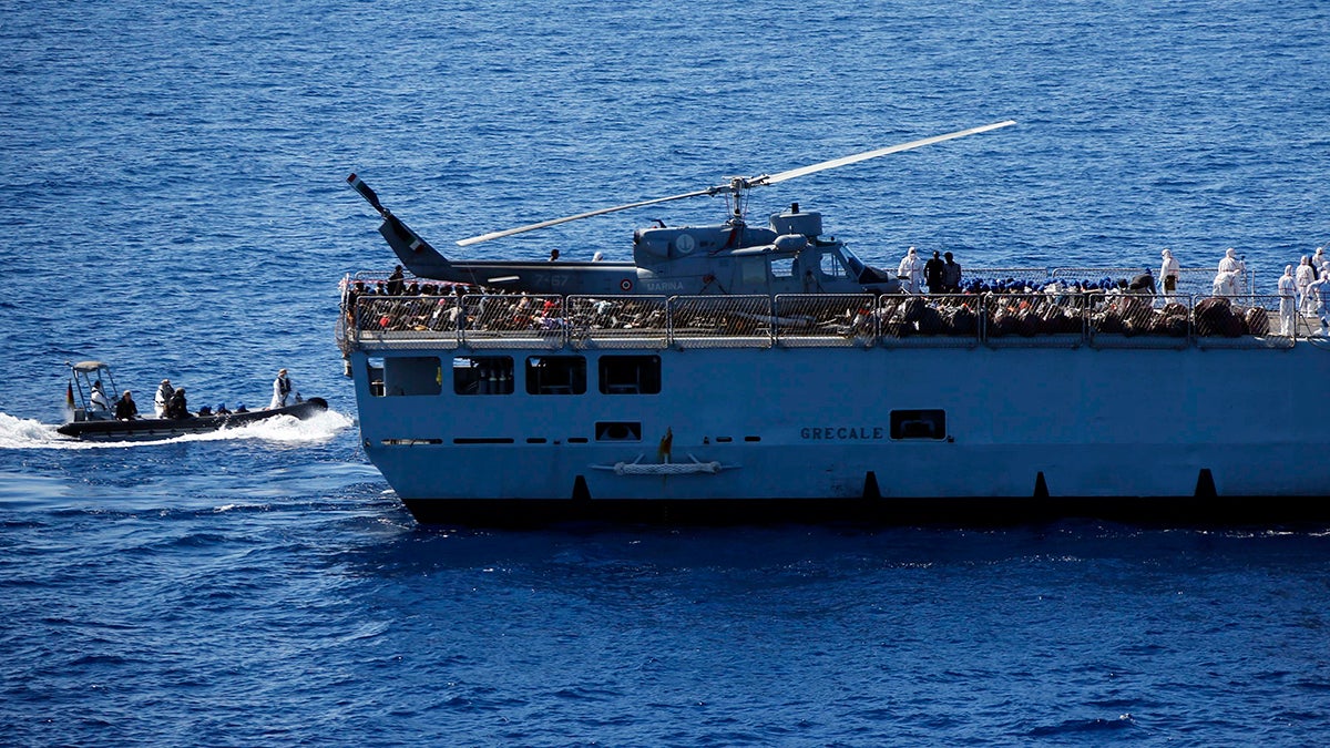 Migrants are transfered by Italian sailors from the German combat supply ship 'Frankfurt am Main' to the their ship 'Grecale' after being rescued during EUNAVFOR MED Operation Sophia in the Mediterranean Sea off the coast of Libya, March 29, 2016.