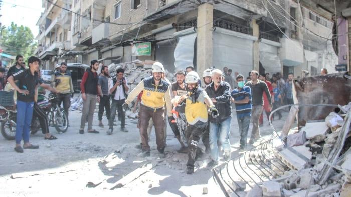 On May 27 a large munition struck a residential area in the town of Ariha, across from the Banat Ariha school, killing at least 13 civilians and wounding at least 21, including four members of Fadel Faham’s.