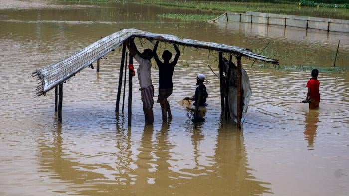 Rohingya refugees repair a shelter damaged following heavy rains at the refugee camp in Kutupalong, Bangladesh on July 28, 2021.