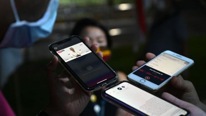 Reporters record a speech by Singapore's Prime Minister Lee Hsien Loong as it is streamed on Facebook live during vote counting in the general election in Singapore, July 11, 2020. 